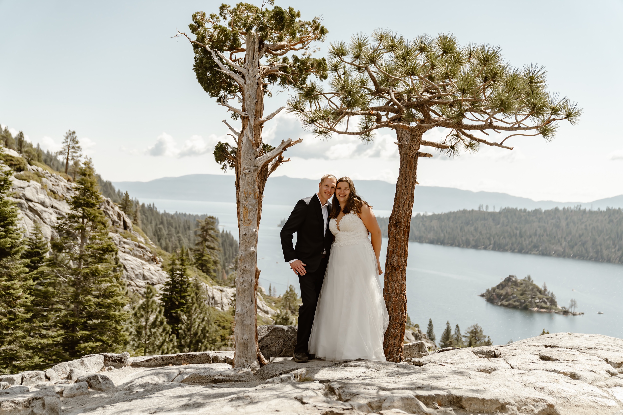 Bride and groom smile in front of Lake Tahoe backdrop