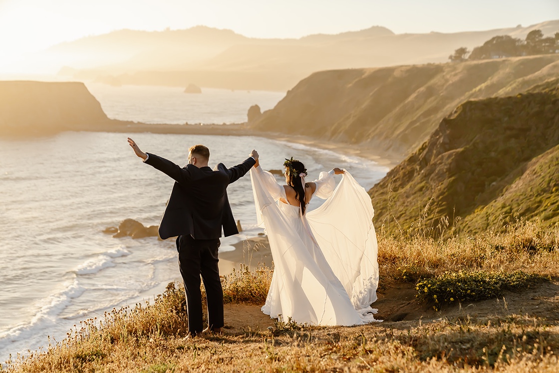 Bride and groom pose for beach elopement photos