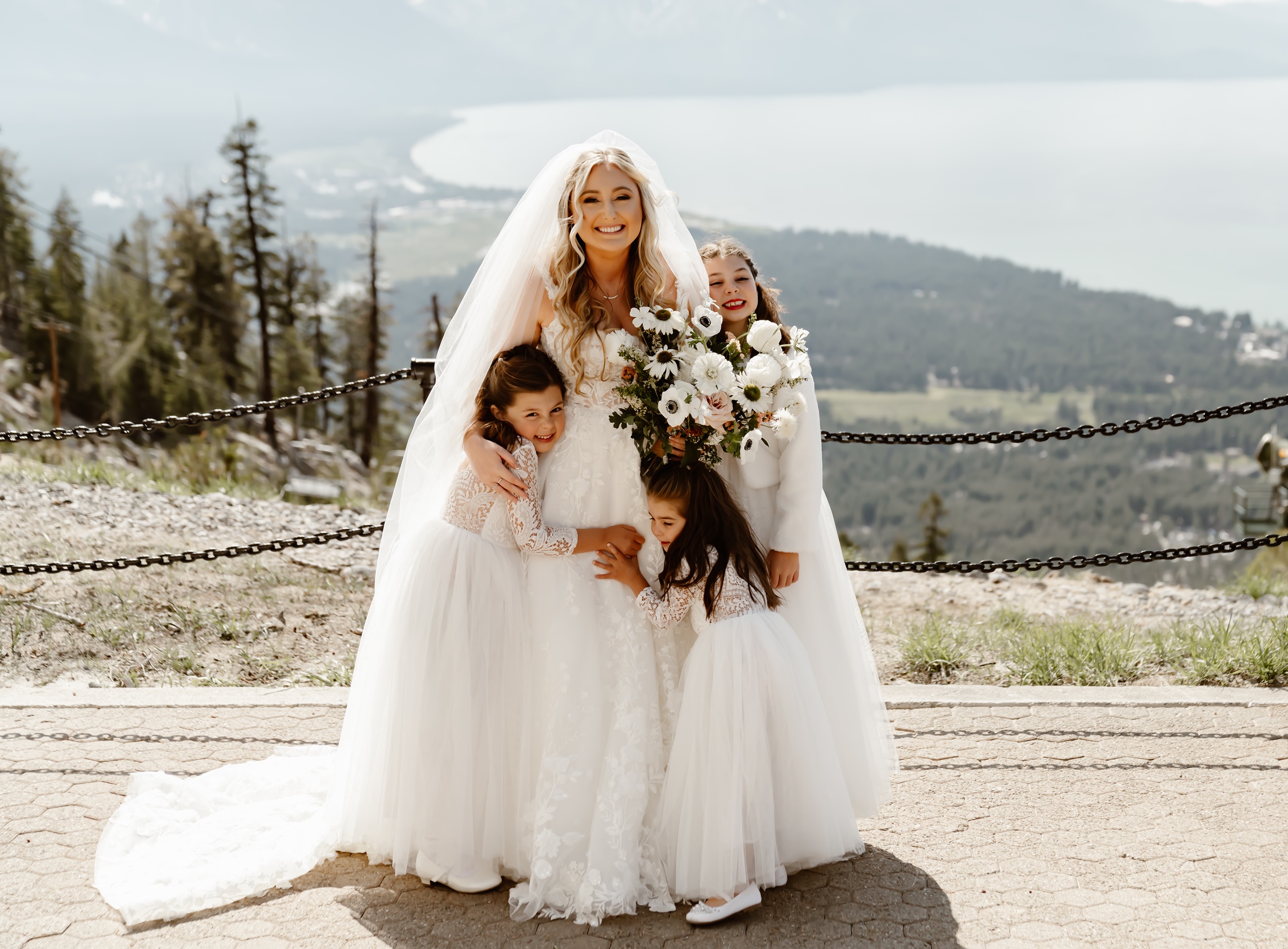 Bride with flower girls with mountain backdrop