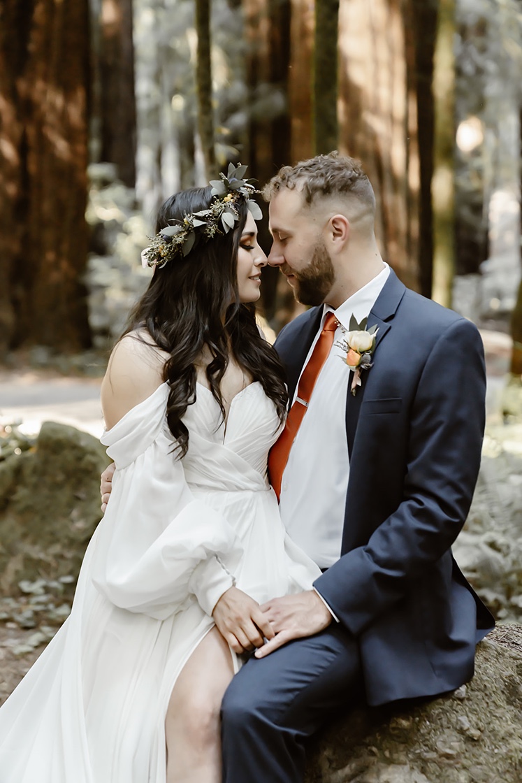 Couple poses at their forest elopement