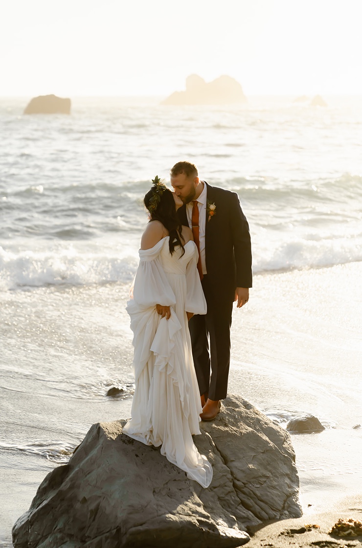 Bride and groom pose for elopement pictures at Shell Beach