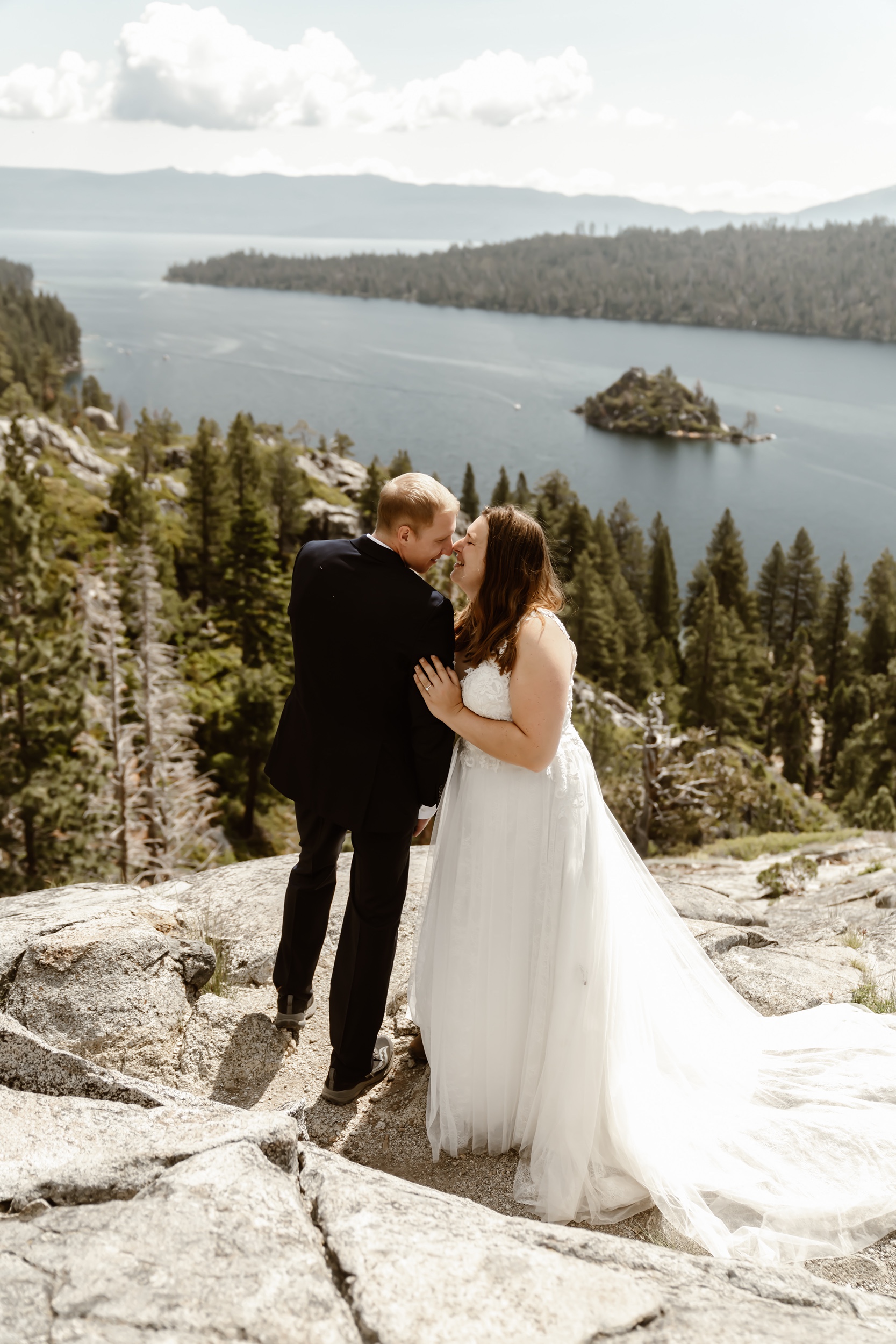Bride and groom kiss with Emerald Bay elopement backdrop