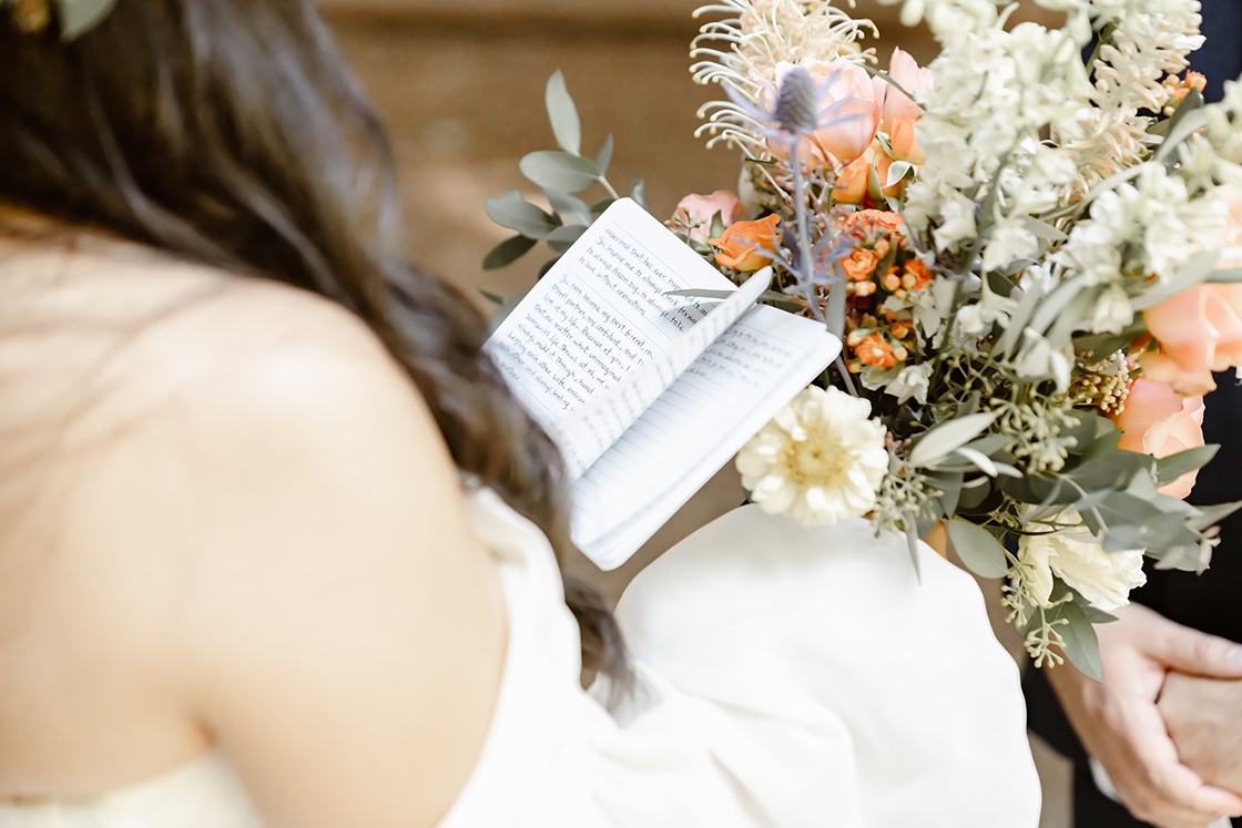 Bride reads vows at the forest elopement