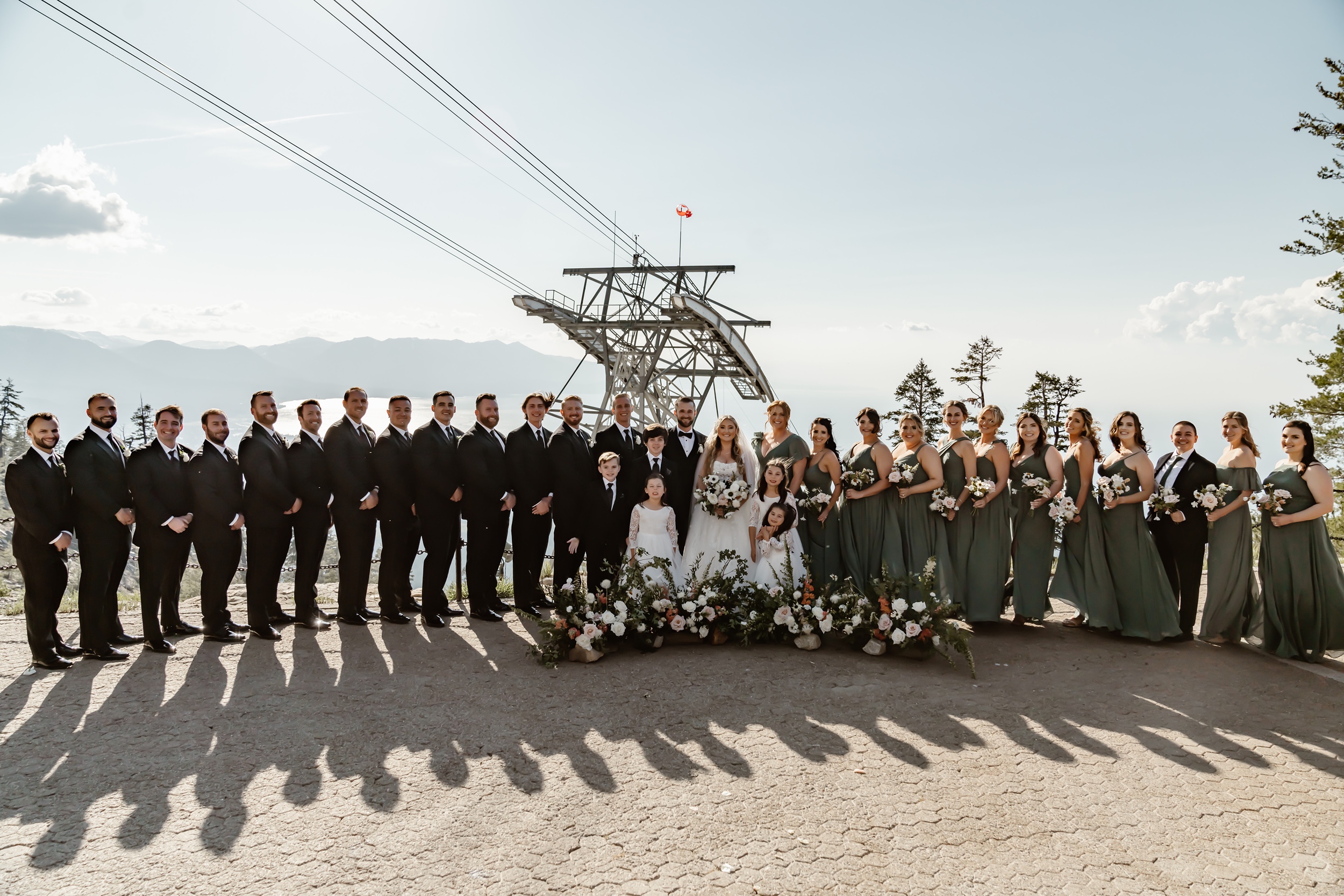 Full wedding party in front of gondola at Heavenly wedding