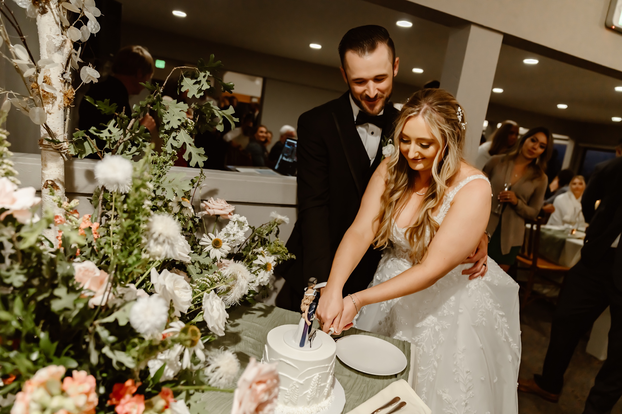 Bride and groom cut cake at the wedding reception