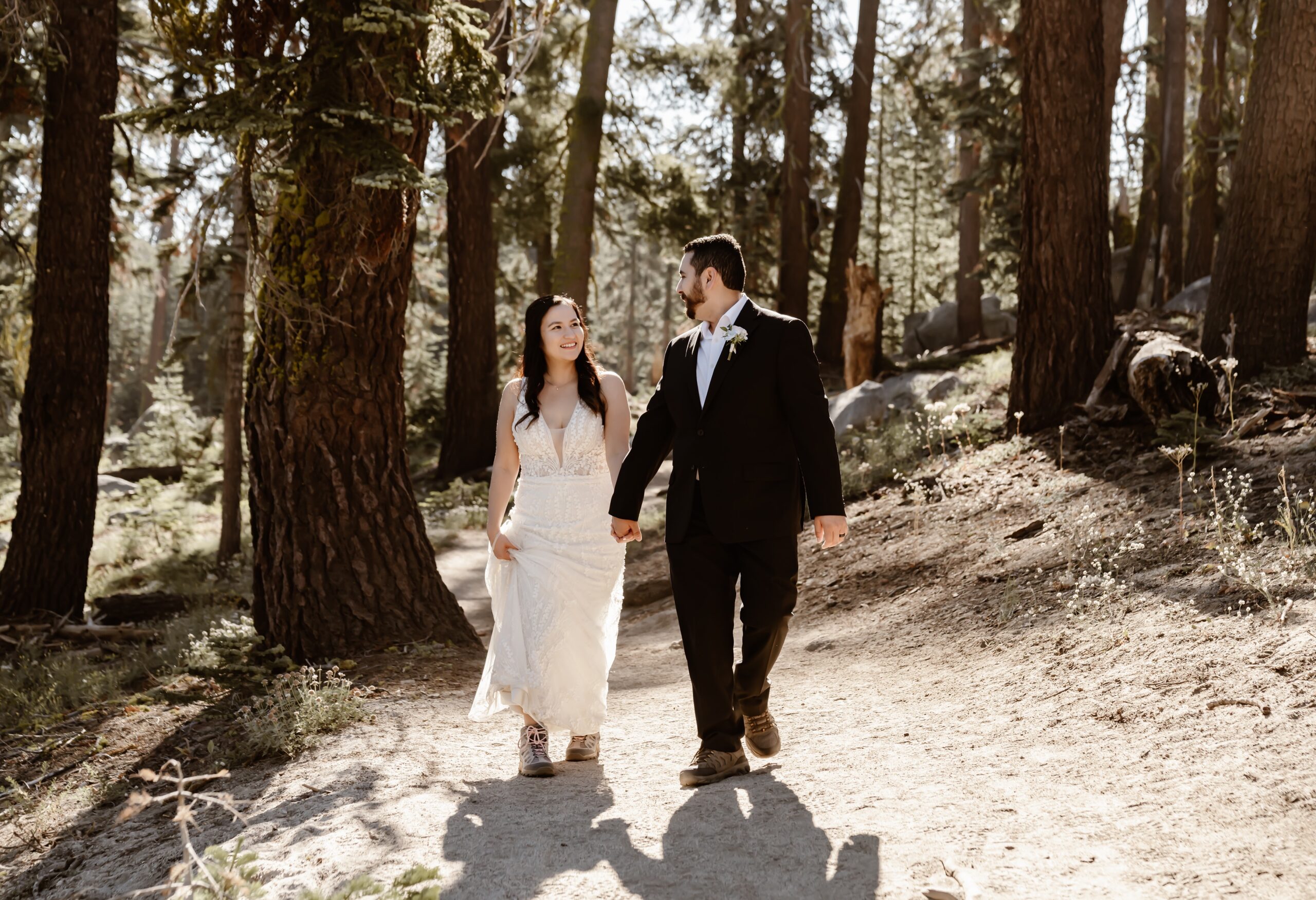 Couple holds hands at Yosemite wedding
