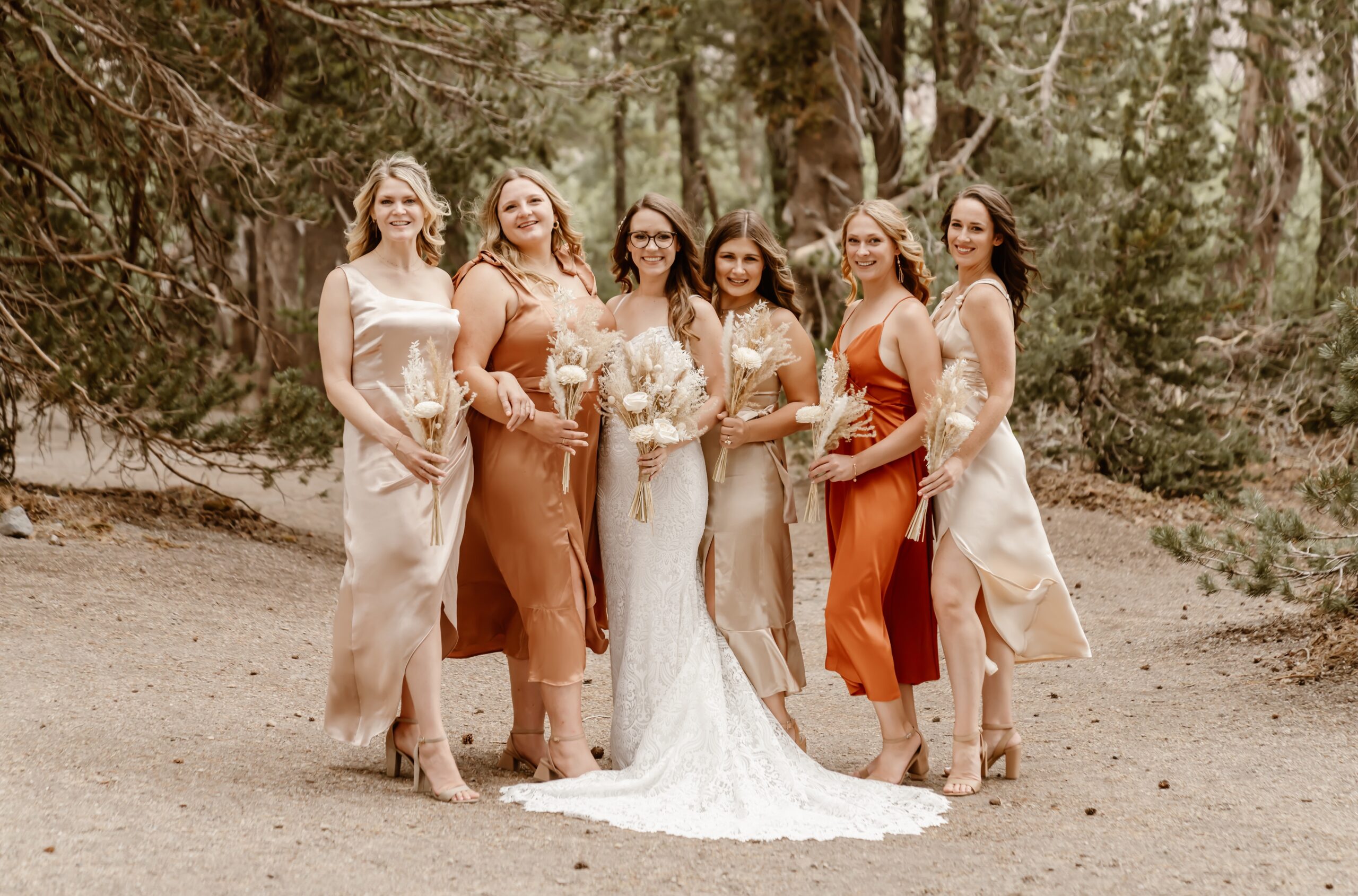 Bridesmaids in shades of orange dresses