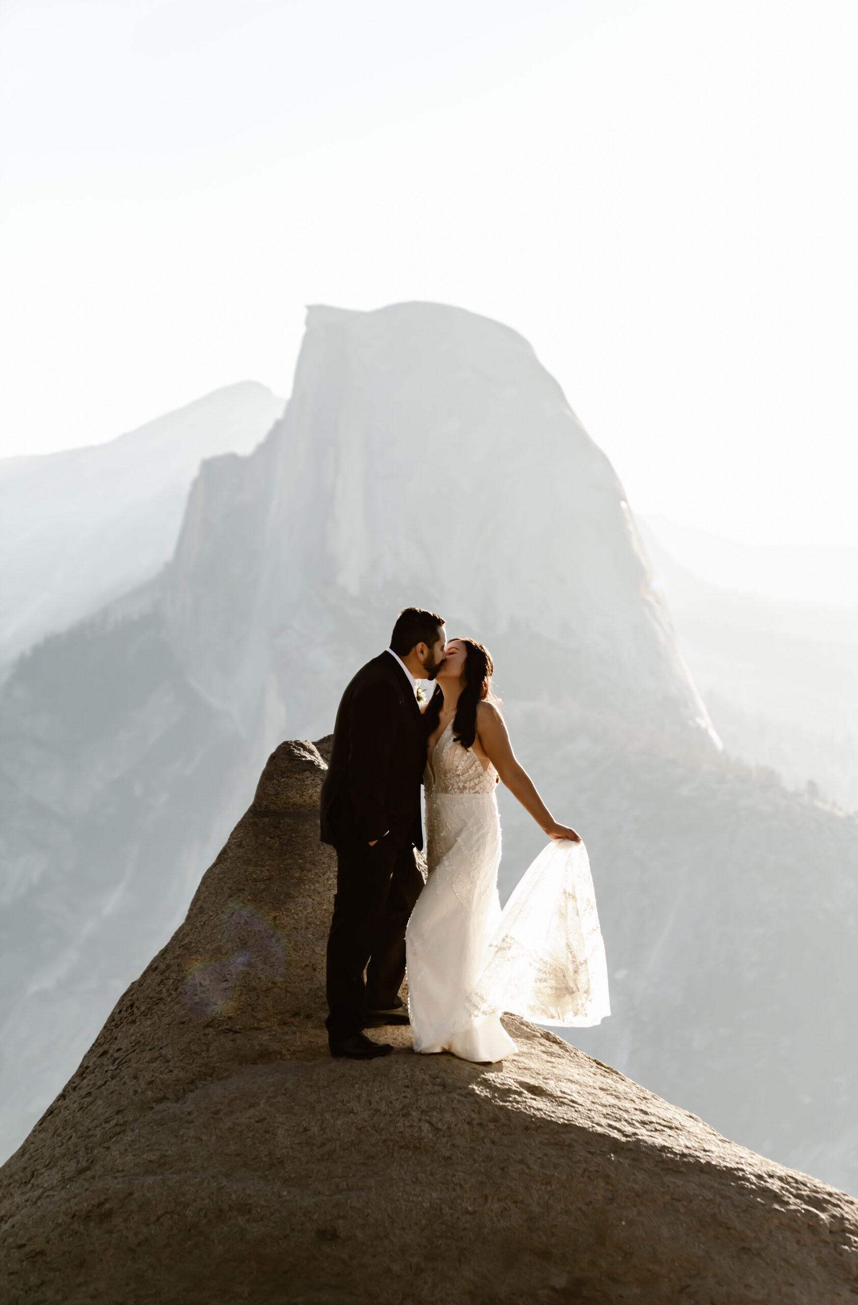 Bride and groom kiss at Glacier Point adventure wedding