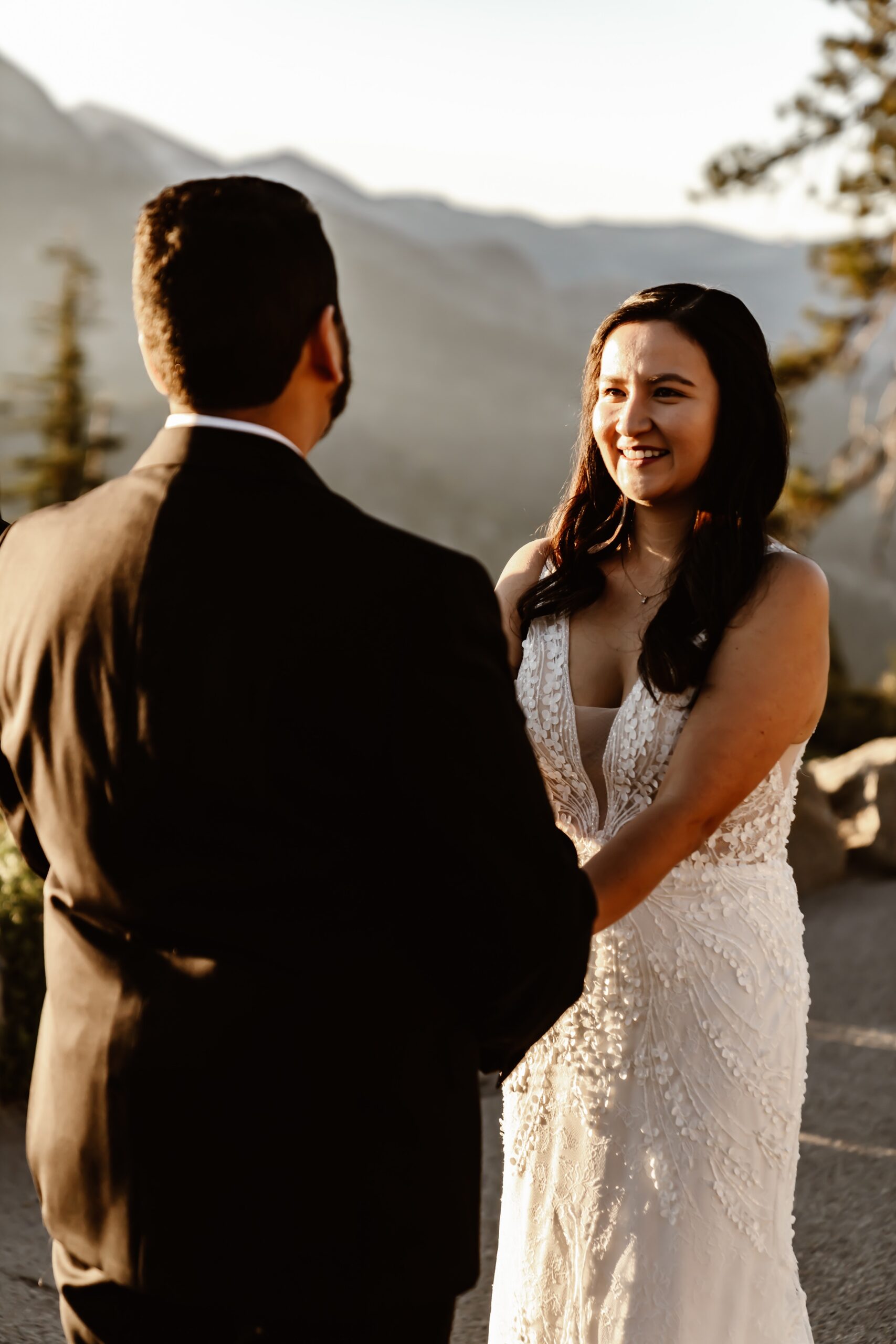 Bride smiles at groom during wedding ceremony in Yosemite