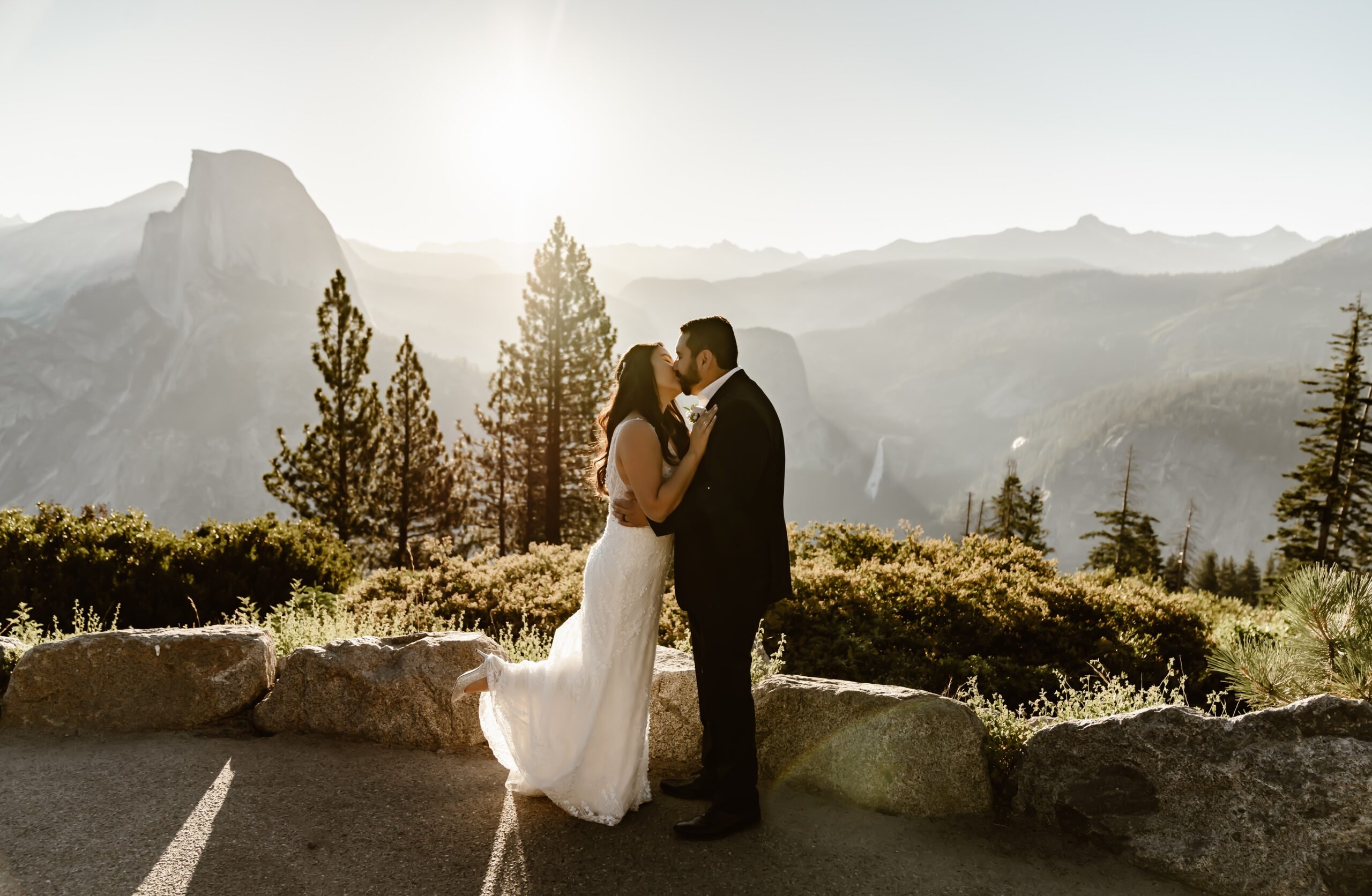 Bride and groom kiss after sunrise Glacier Point wedding ceremony