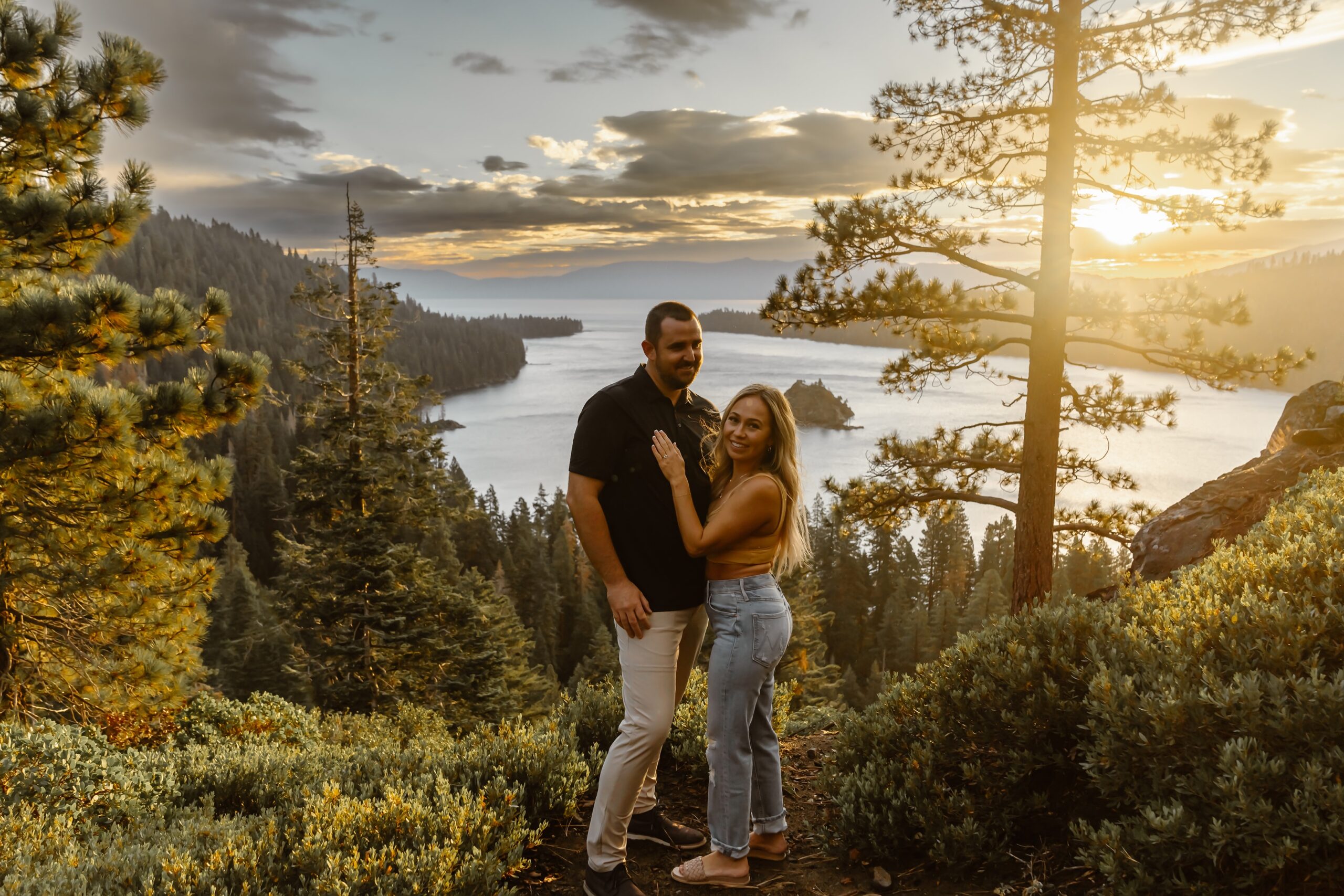Man and woman smile at sunrise at Lake Tahoe