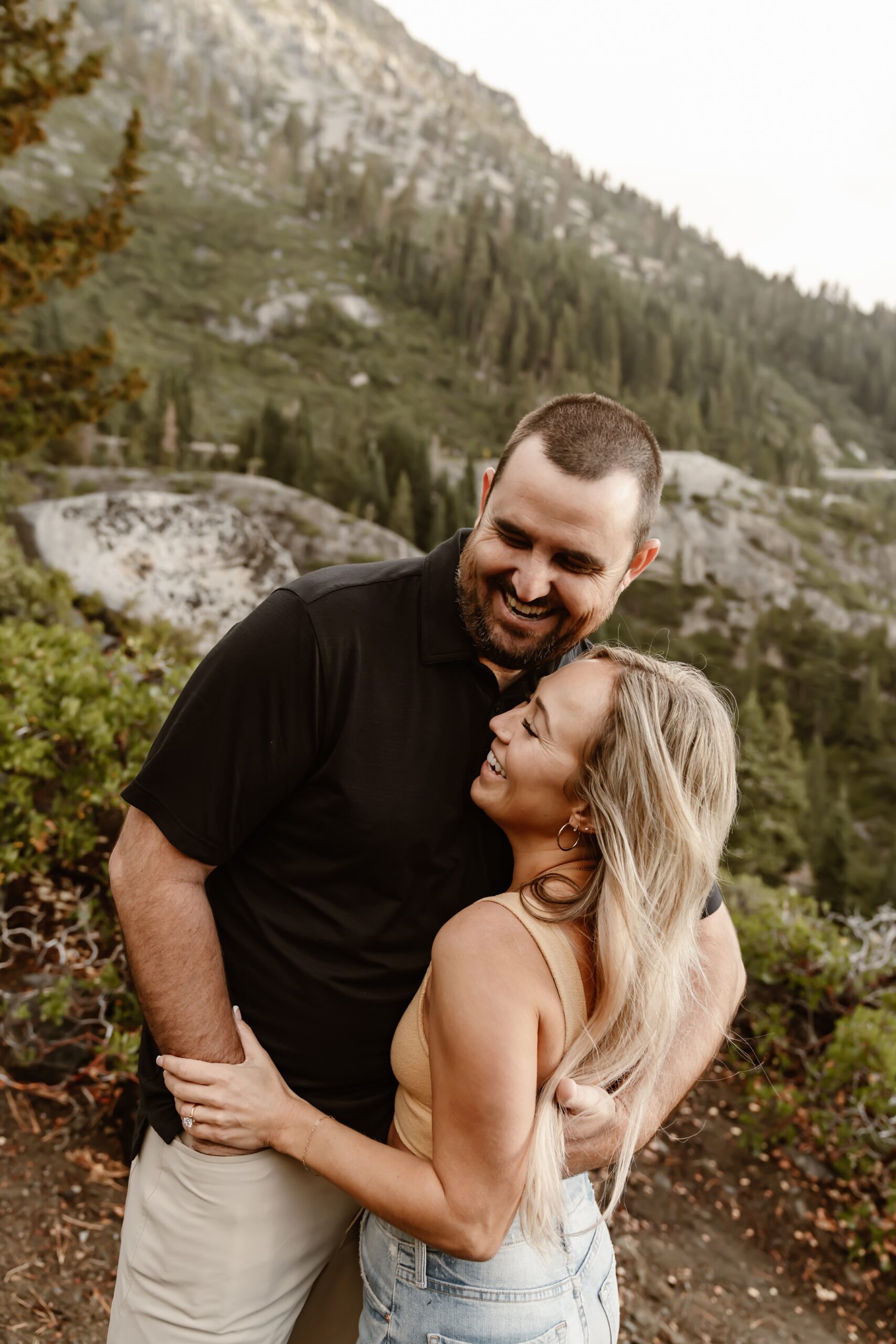 Couple laughs at Emerald Bay engagement photo session