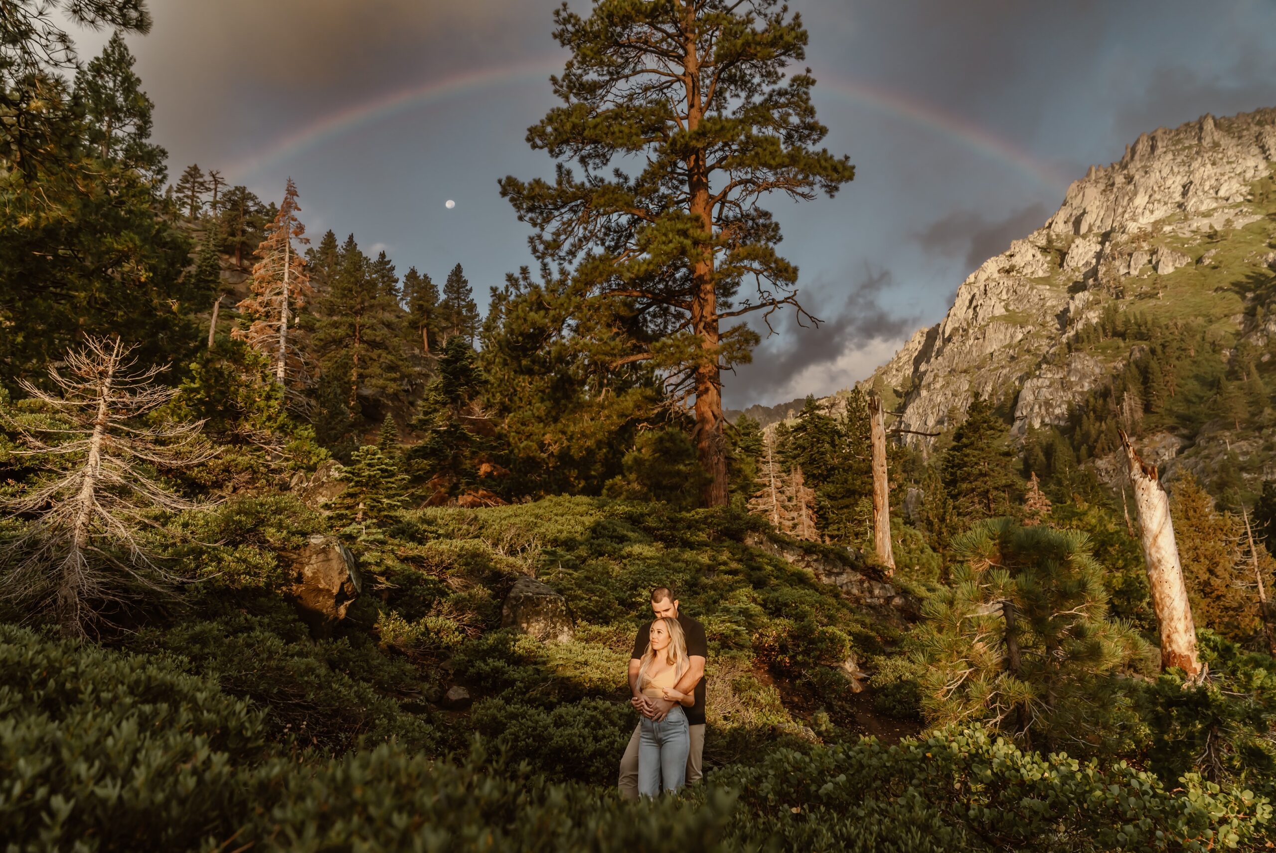 Couple with rainbow at Lake Tahoe proposal