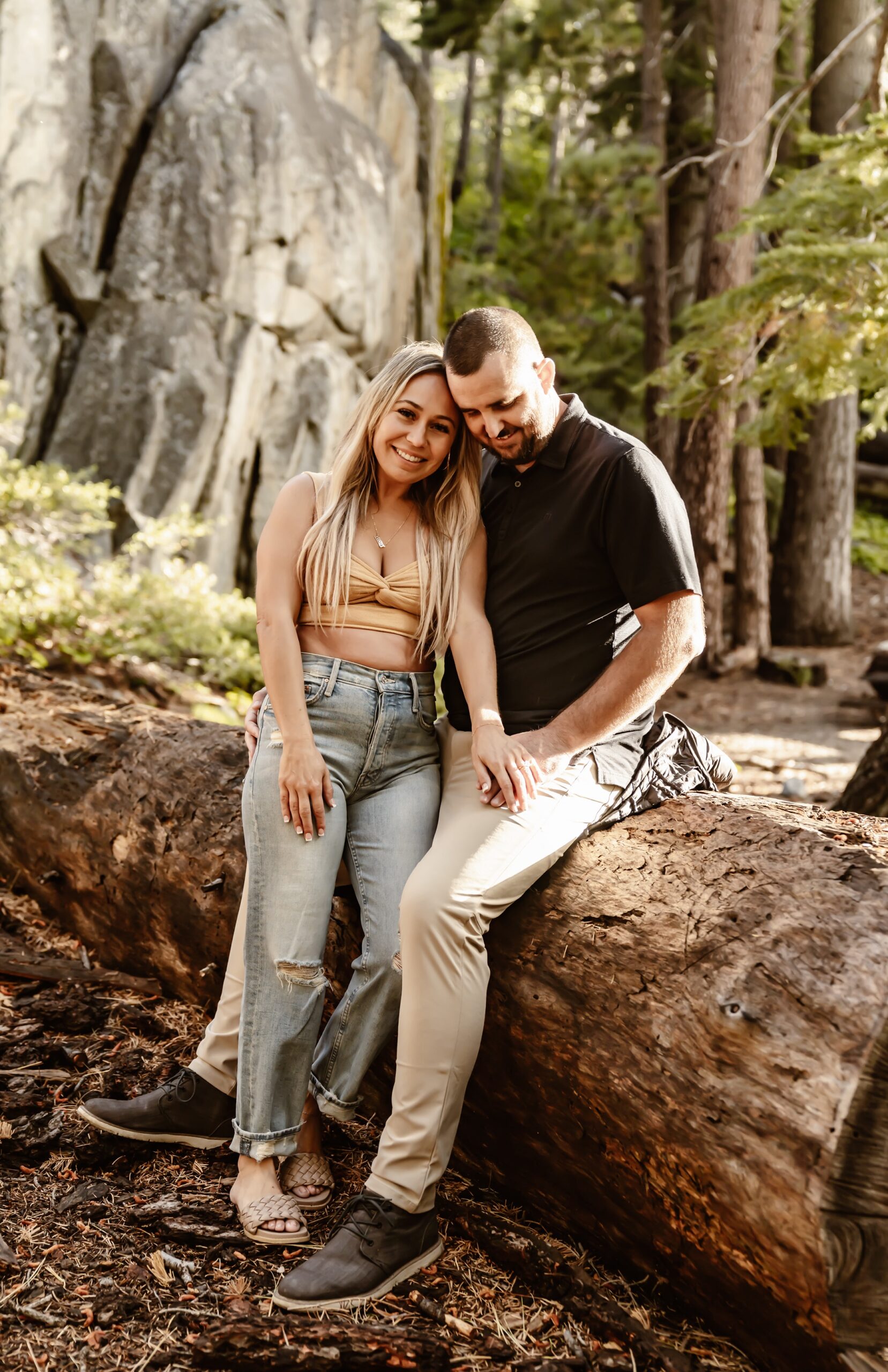 Couple sits on tree during Lake Tahoe engagement session