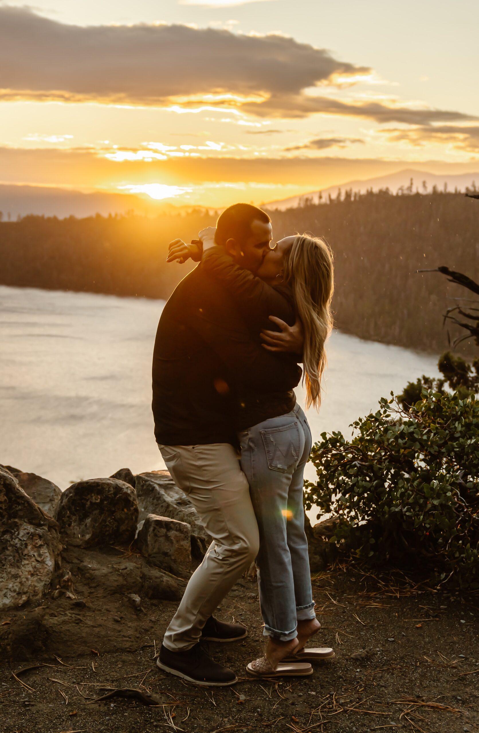 Couple hugs after sunrise Lake Tahoe proposal