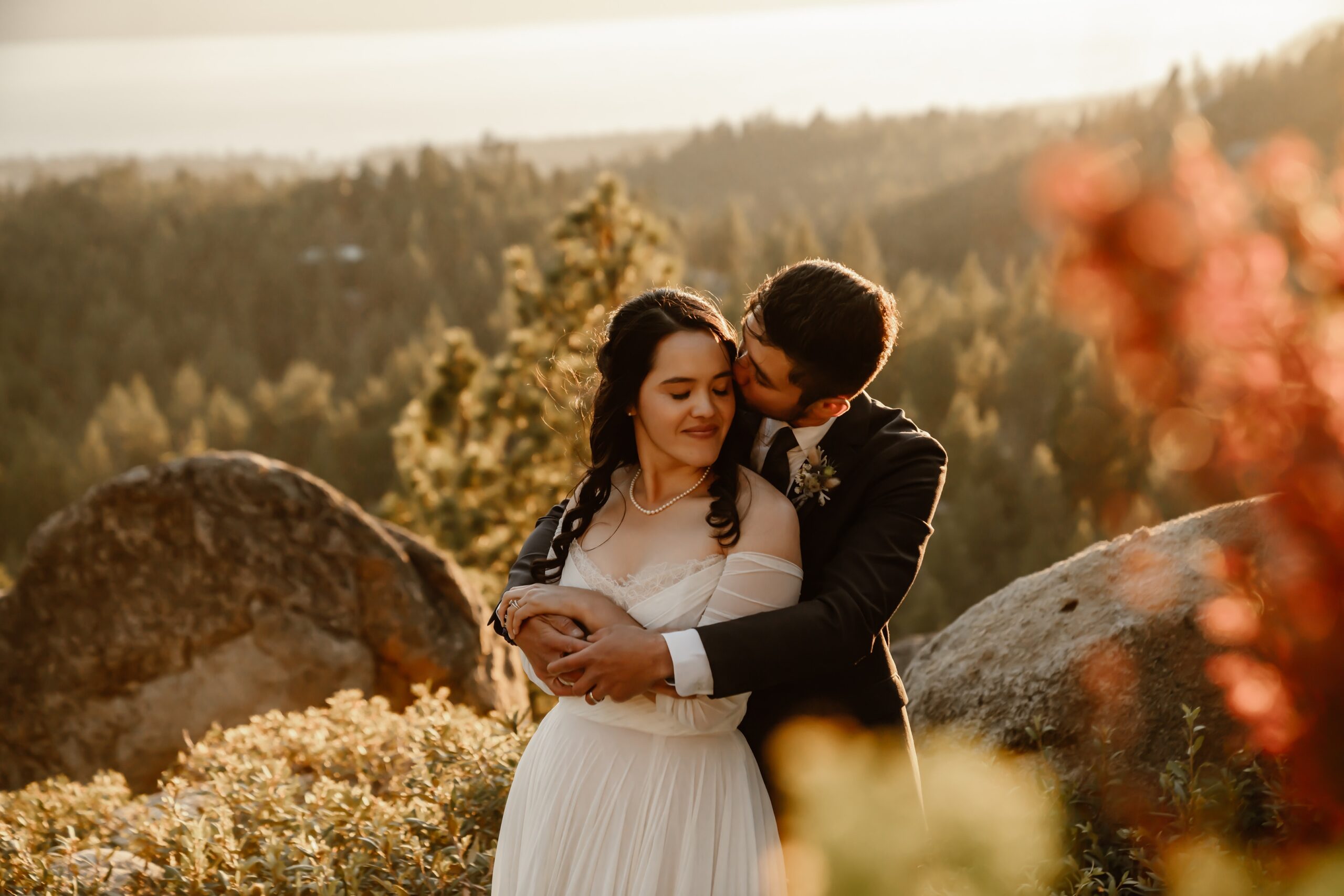Groom kisses bride during sunset portraits