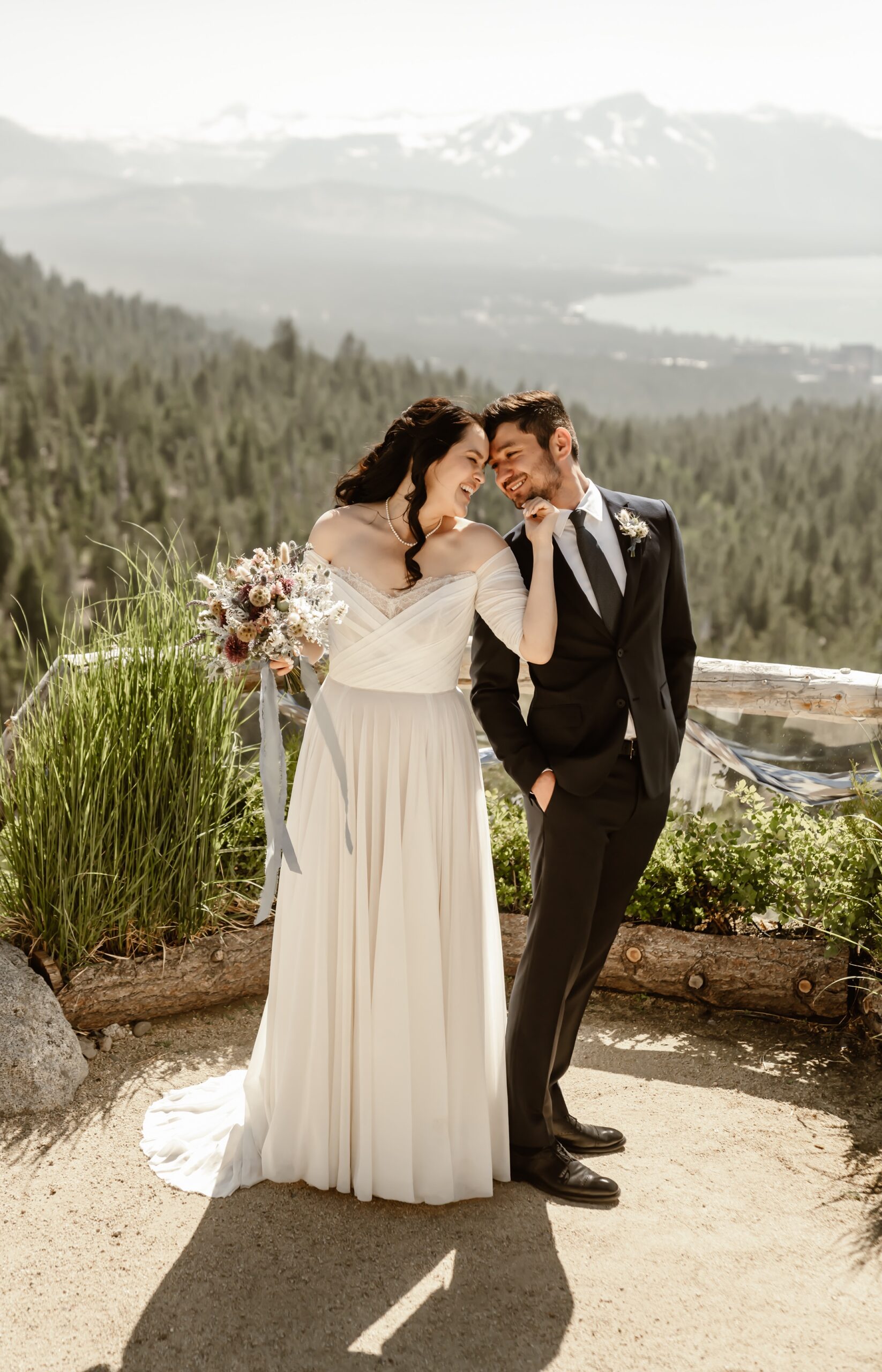 Bride and groom smile with Lake Tahoe wedding backdrop