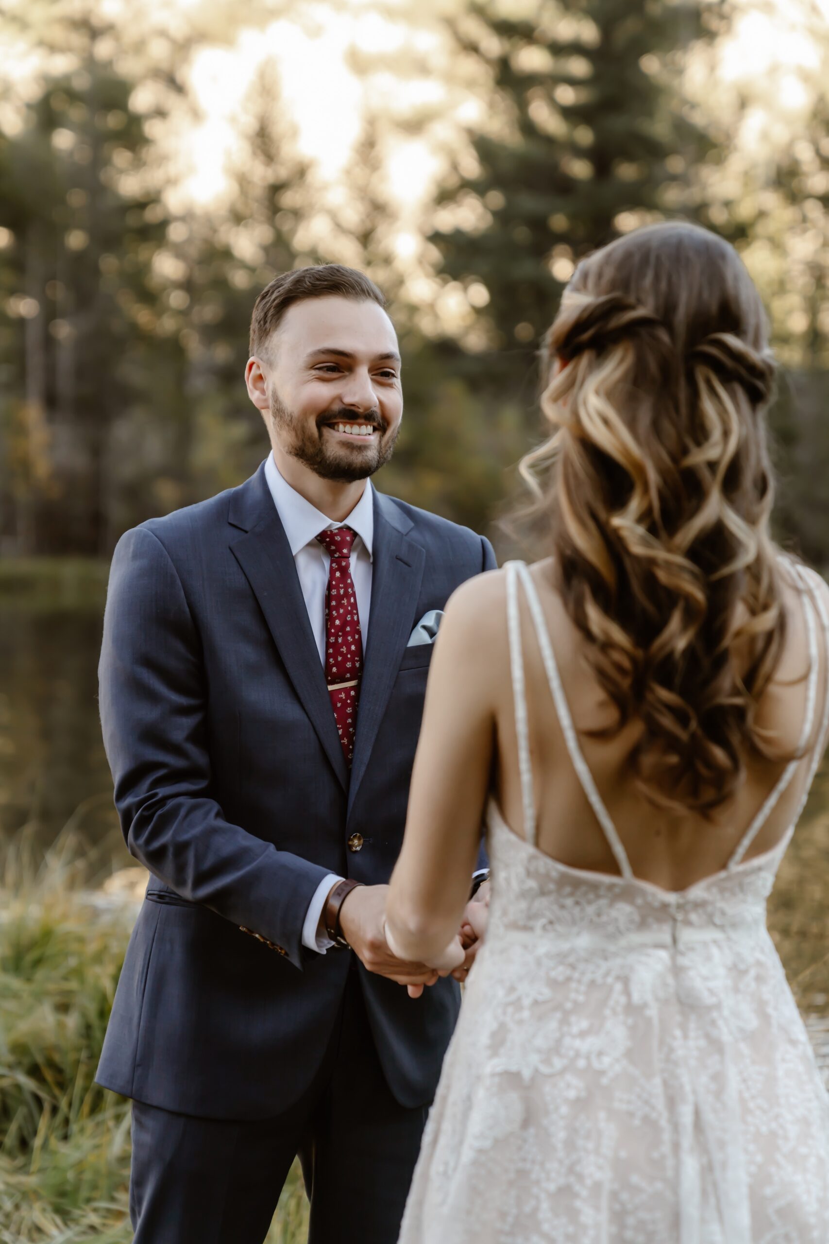 Bride and groom hold hands during Mammoth Lakes elopement ceremony