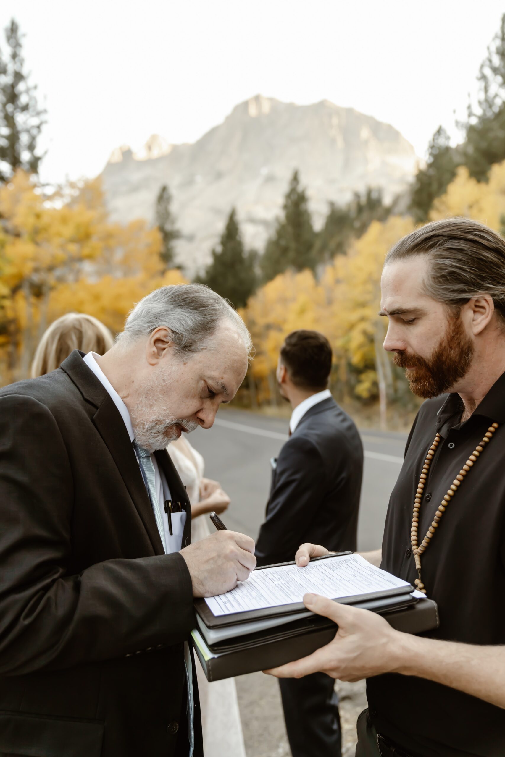 Witness signs paperwork at the Mammoth Lakes elopement
