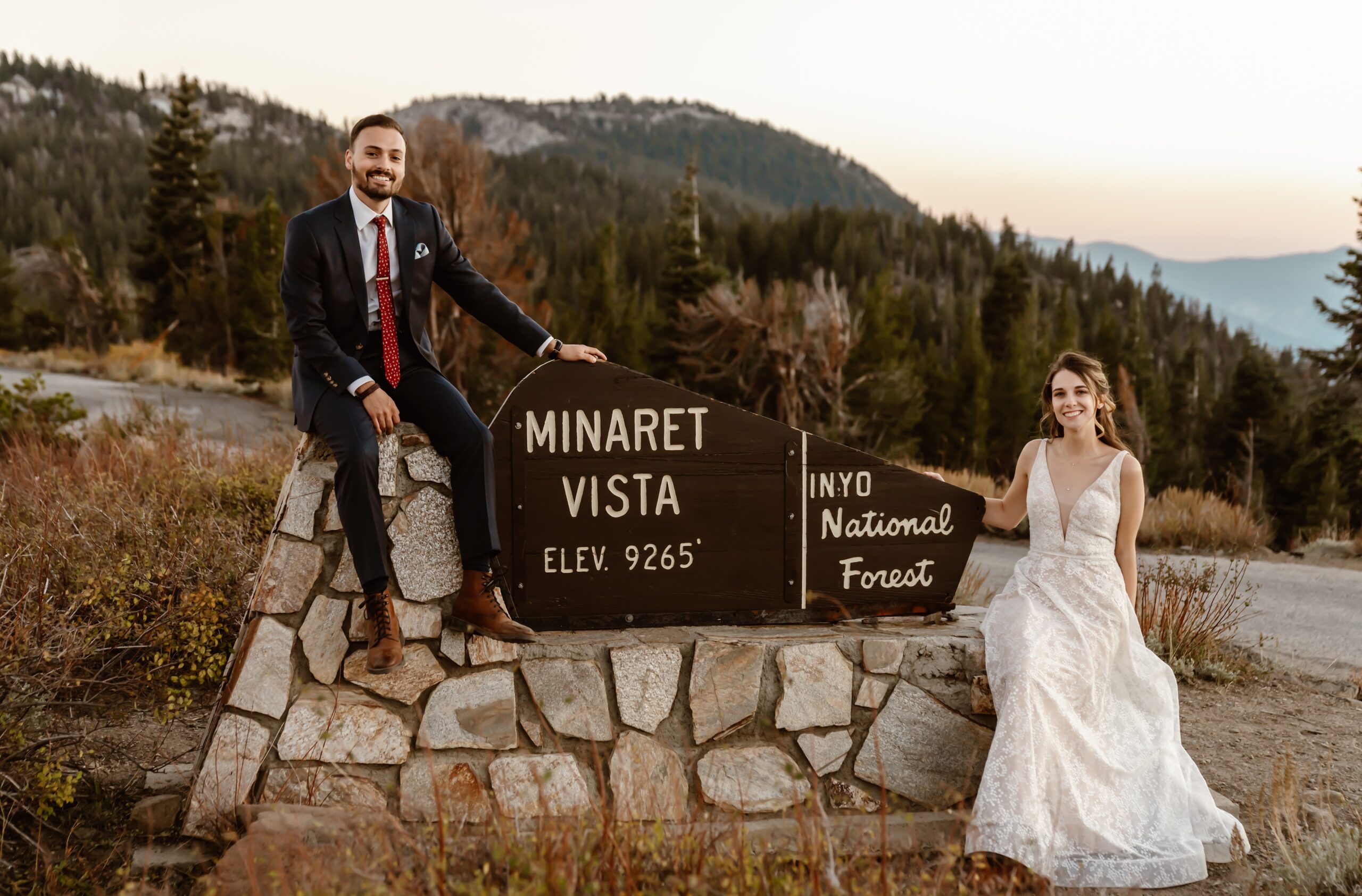 Bride and groom pose with the Minaret Vista sign