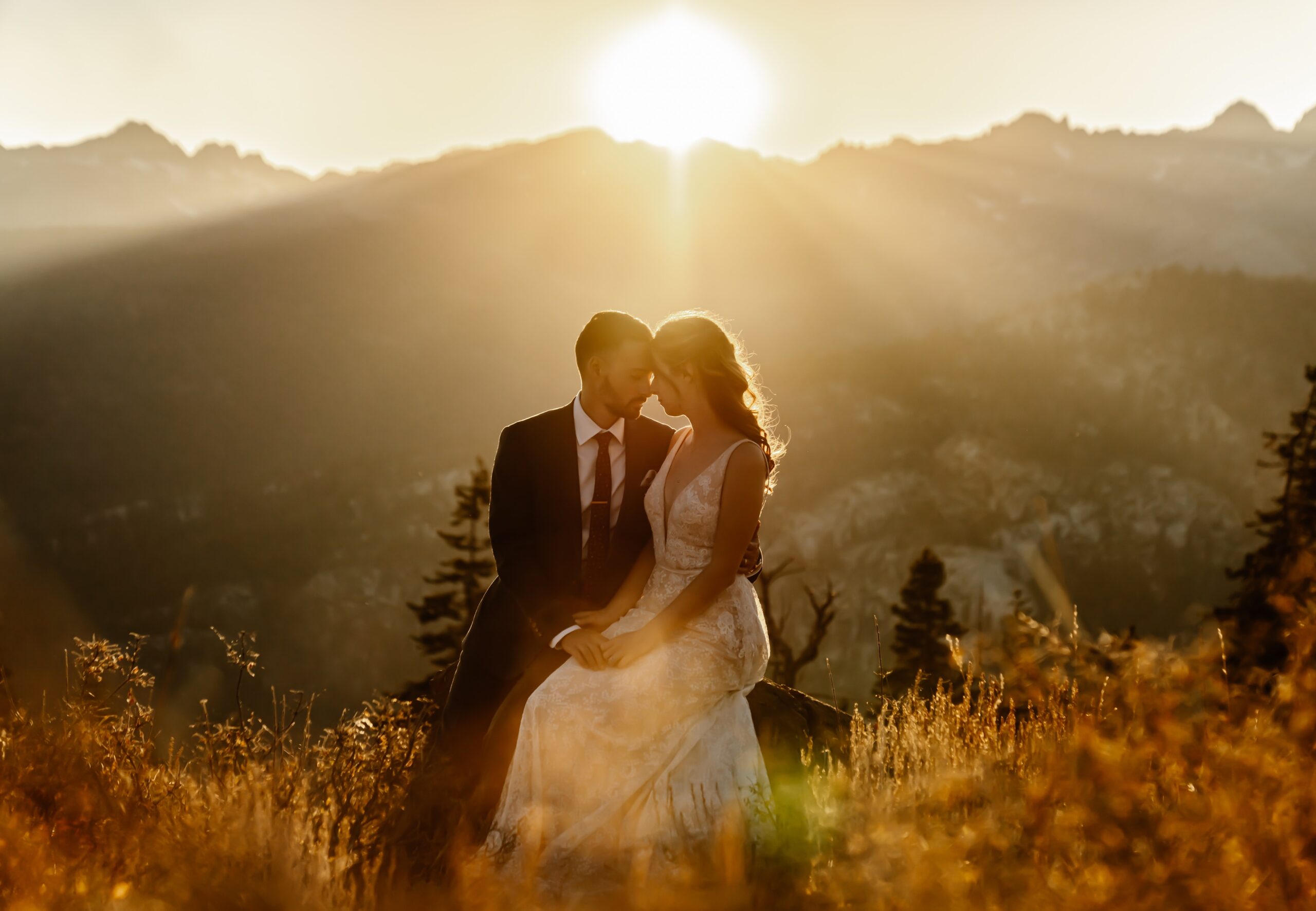 Bride and groom with the sun setting behind them