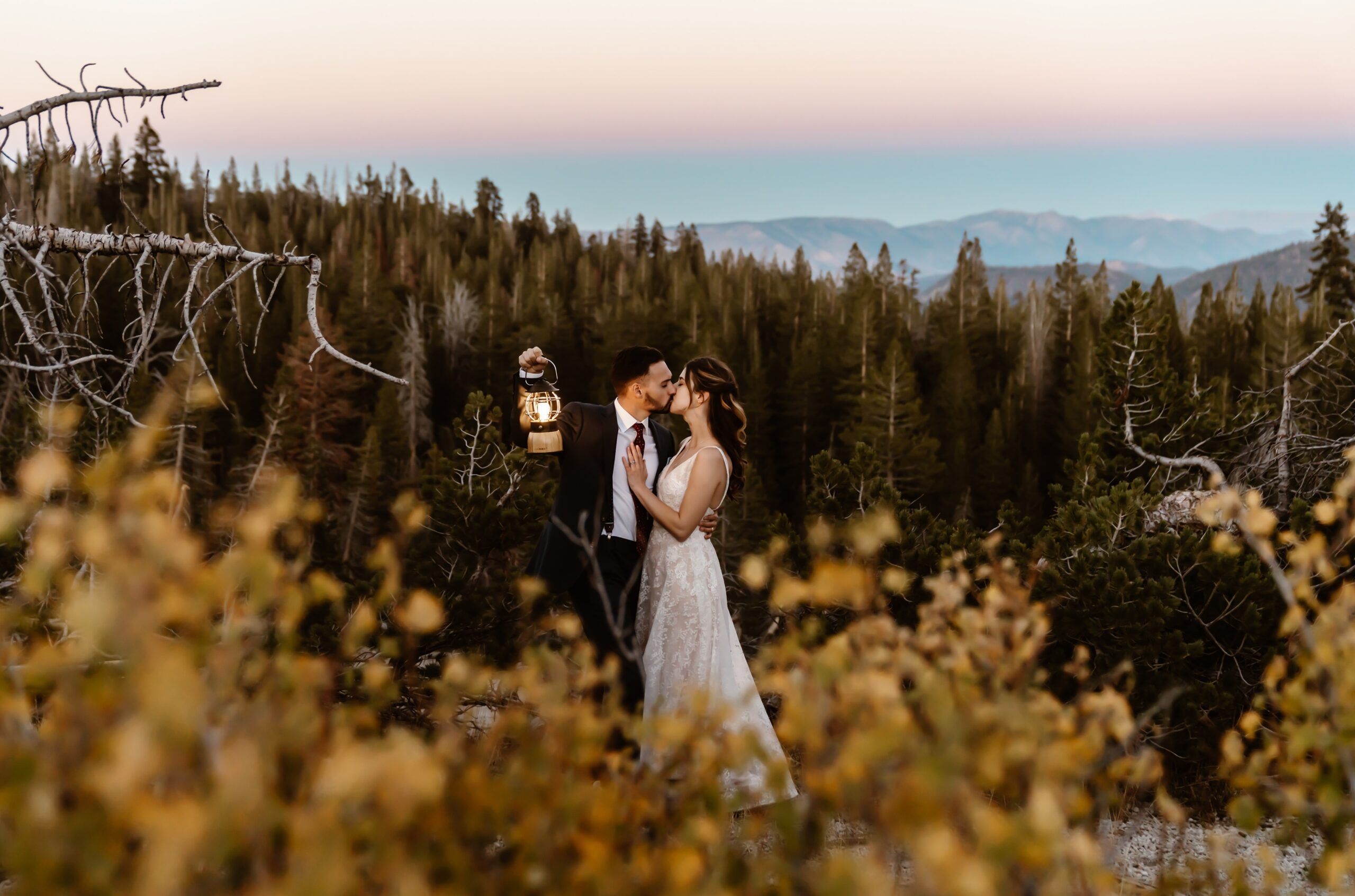 Bride and groom hold lantern in Mammoth Lakes