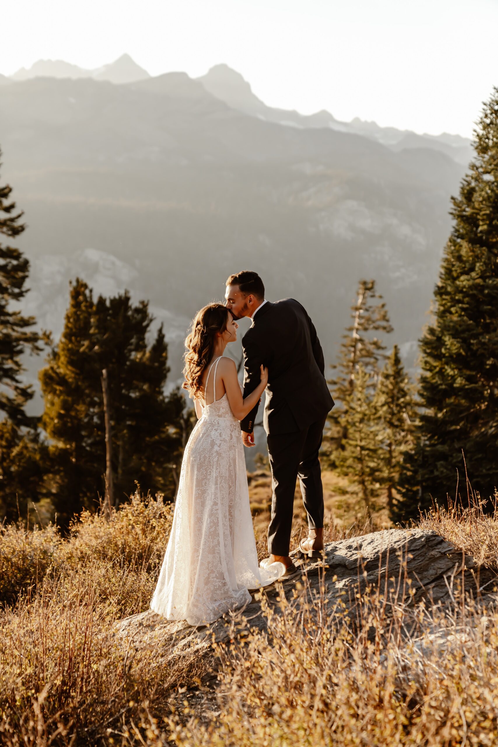 Bride and groom look out over mountains in Mammoth Lakes