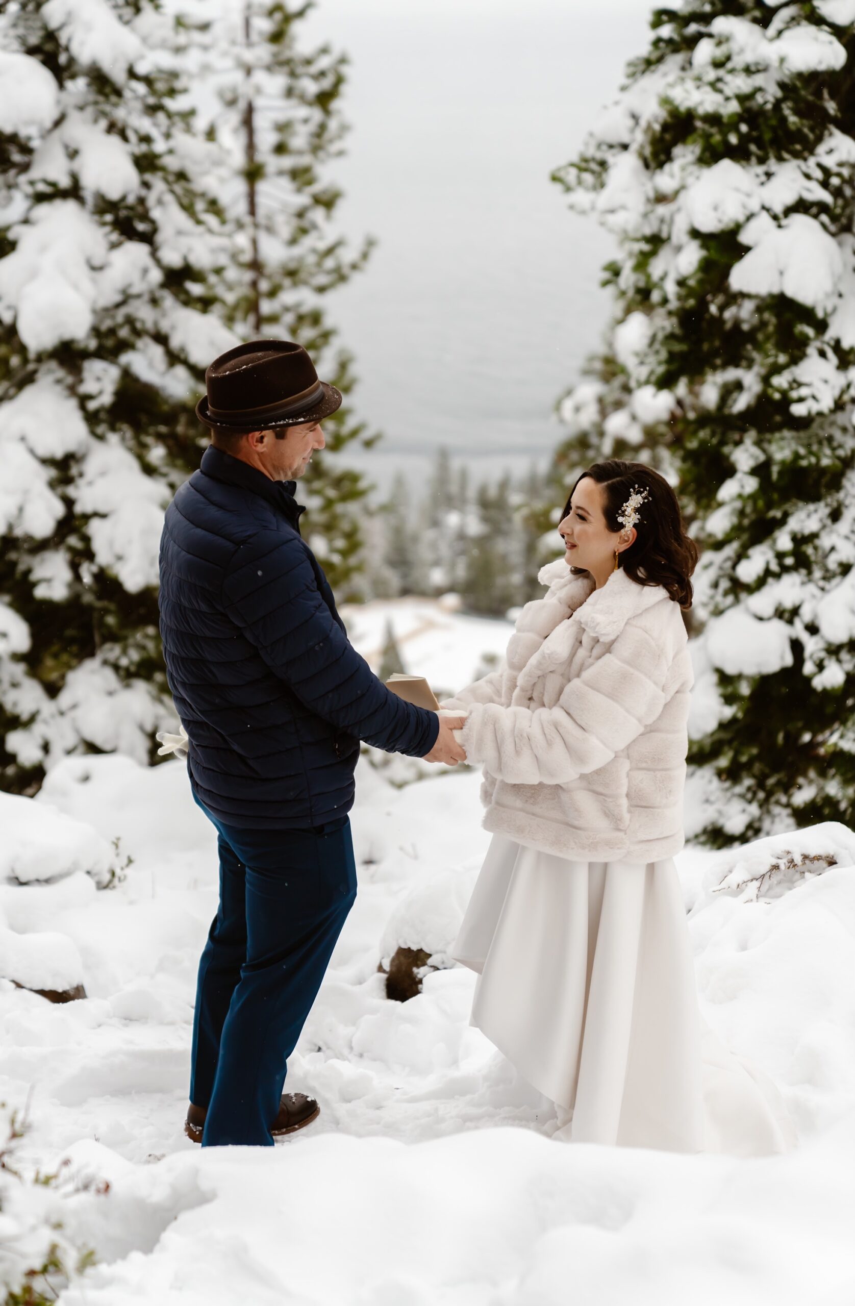 Bride and groom say vows in the snowy mountains