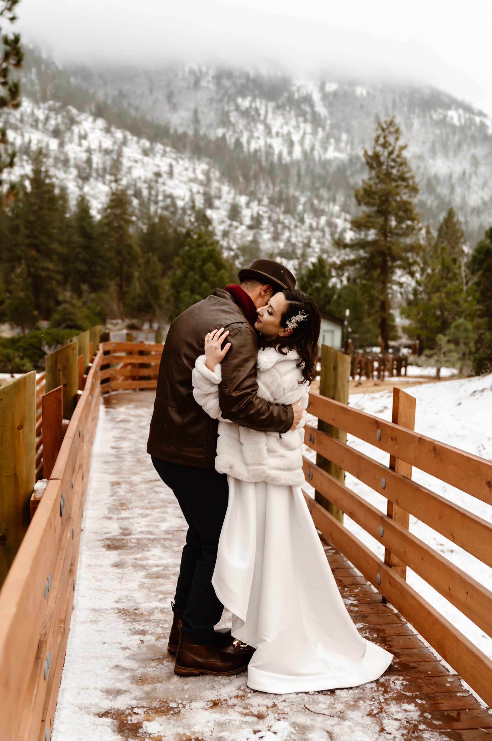 Bride and groom dance at their snowy mountain elopement