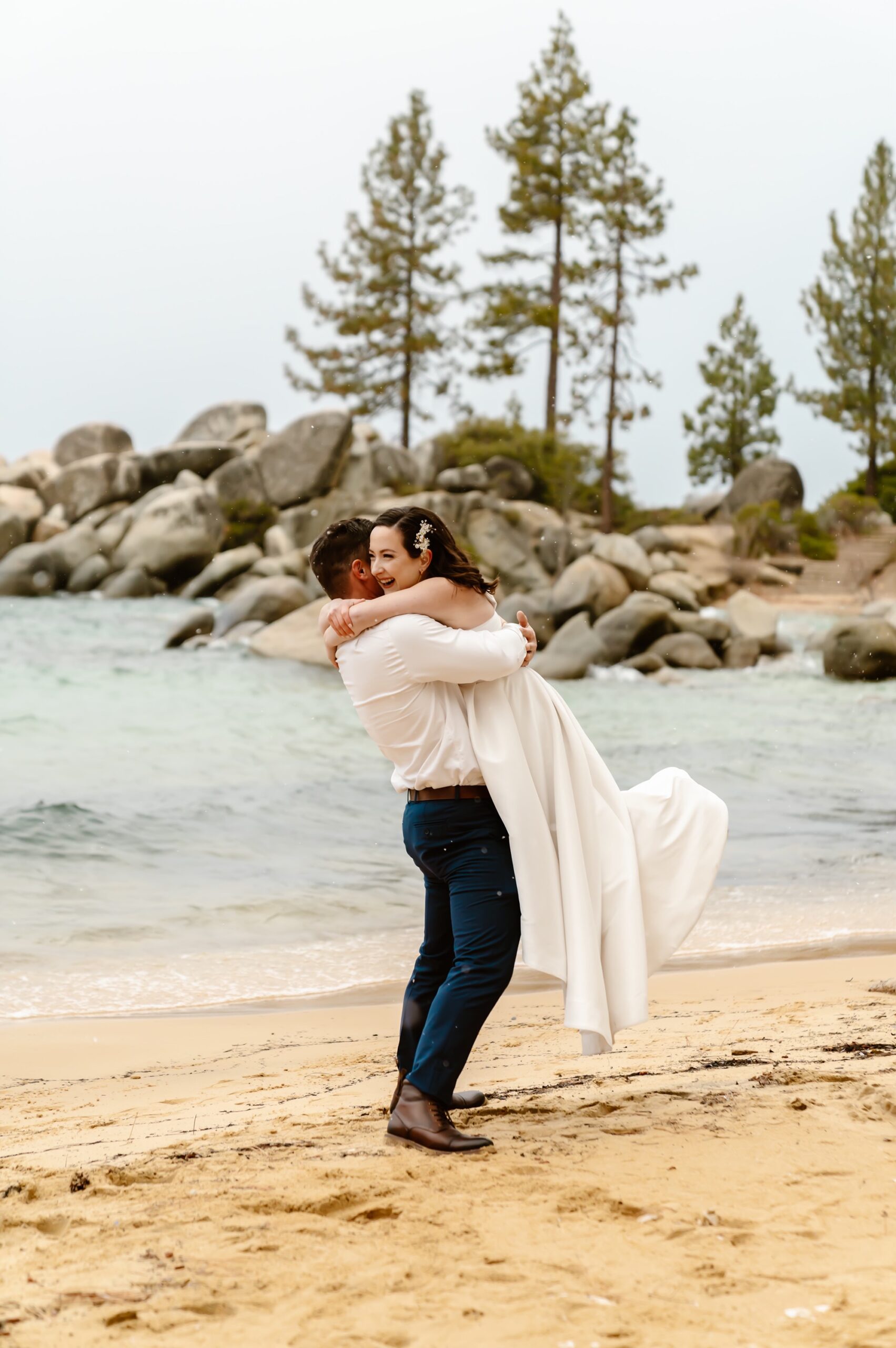 Bride and groom hug at their snowy elopement