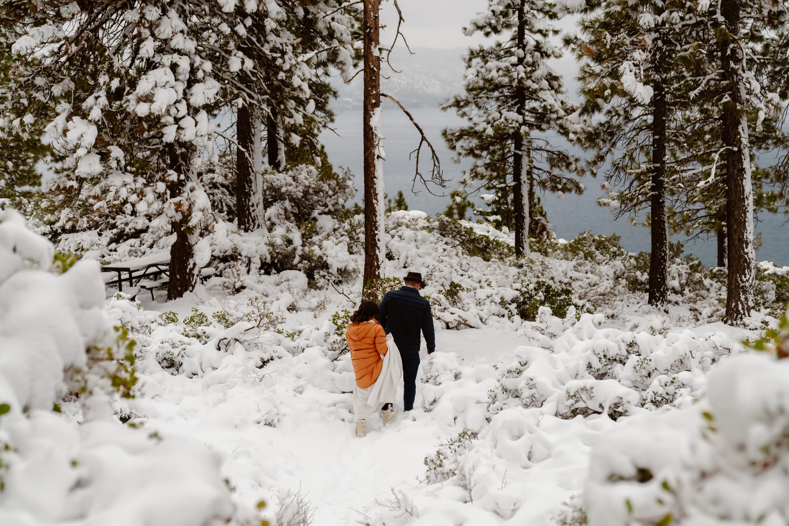 Bride and groom set out on snowy elopement hike