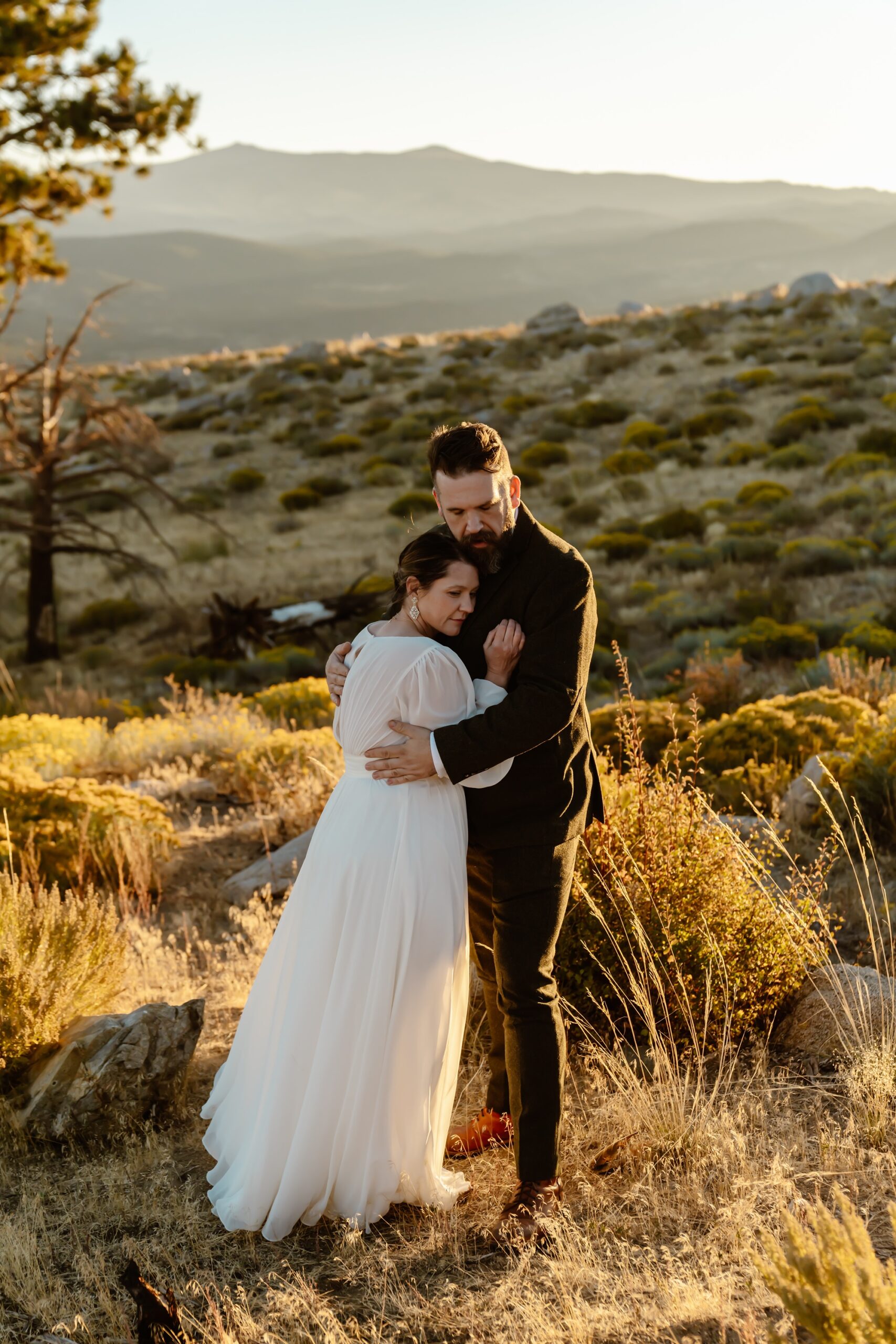 Bride and groom hug at sunrise elopement near Mono Lake