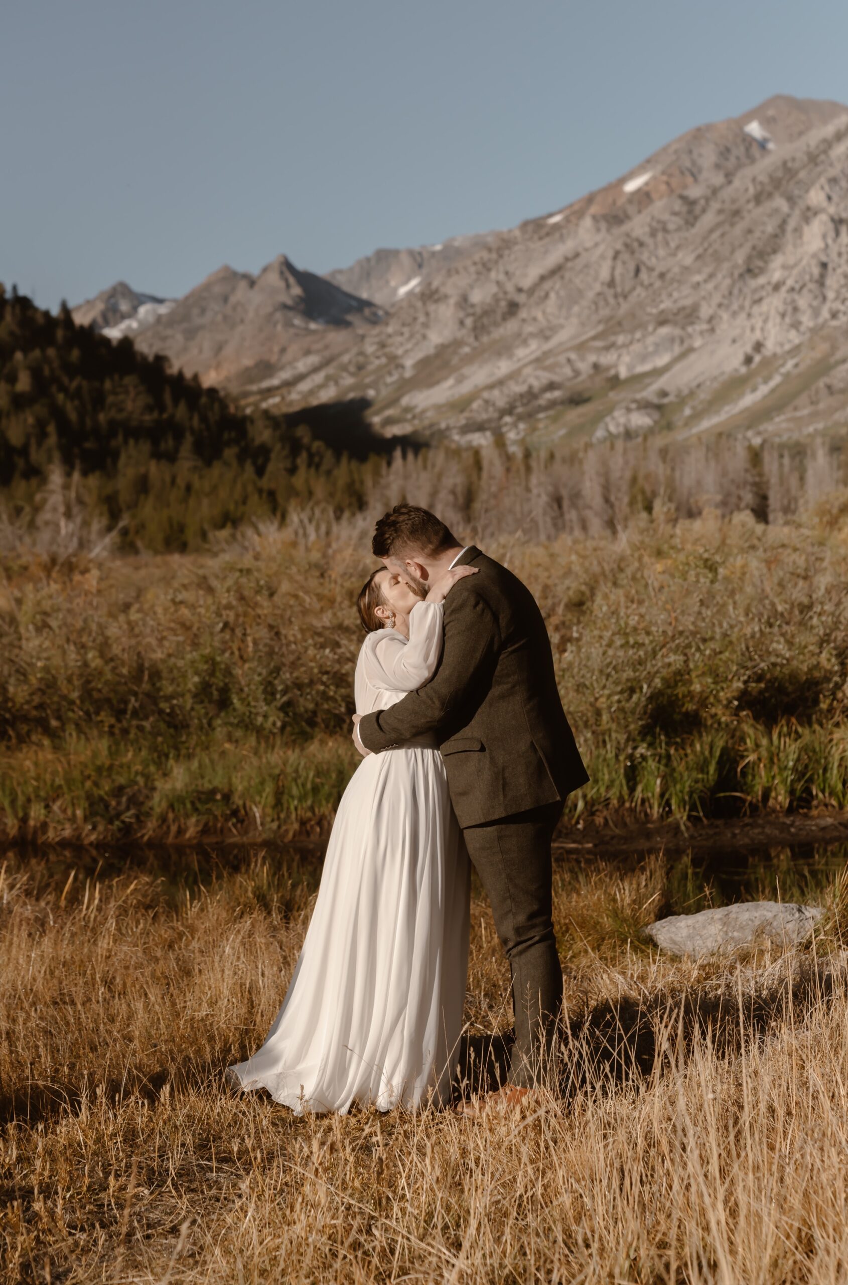 Bride and groom kiss at elopement ceremony near Mono Lake