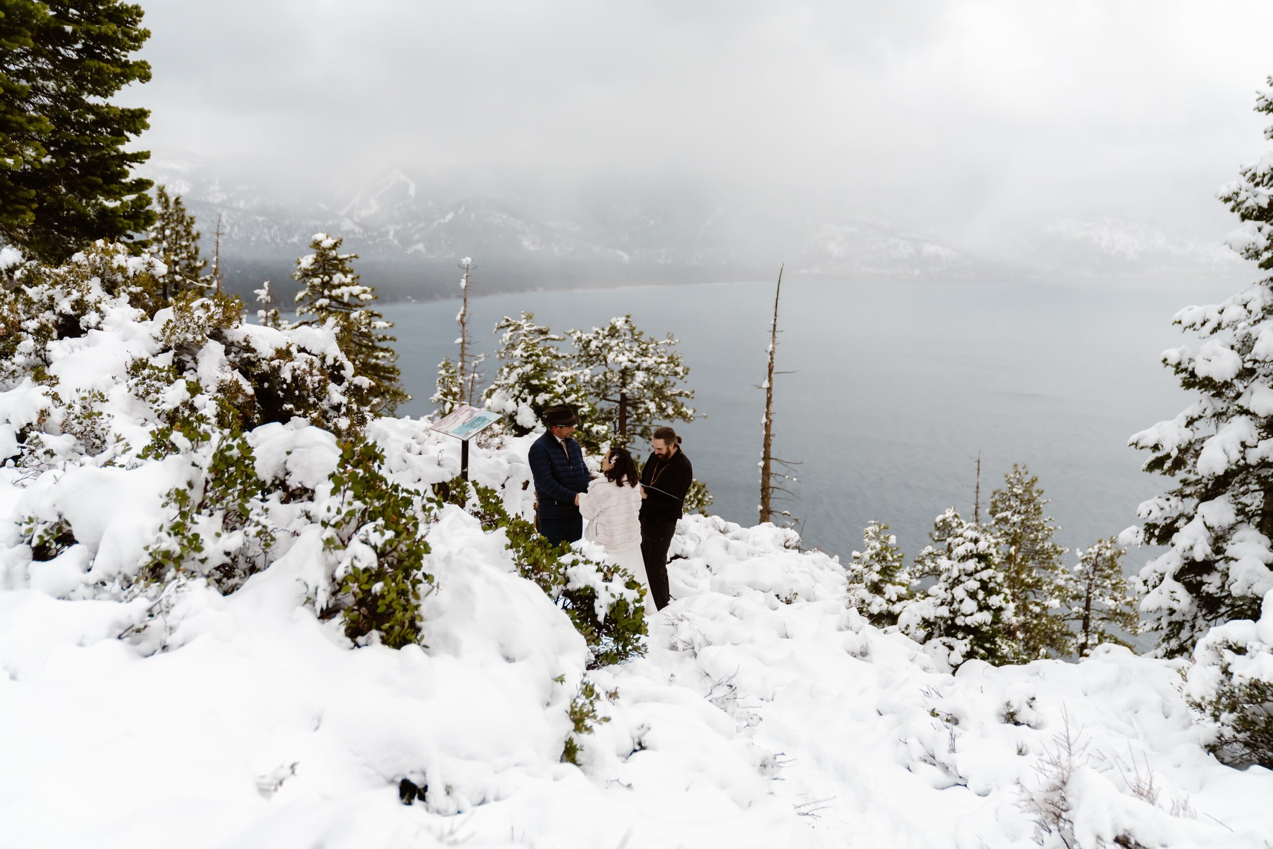 Bride and groom say vows overlooking Lake Tahoe in the winter