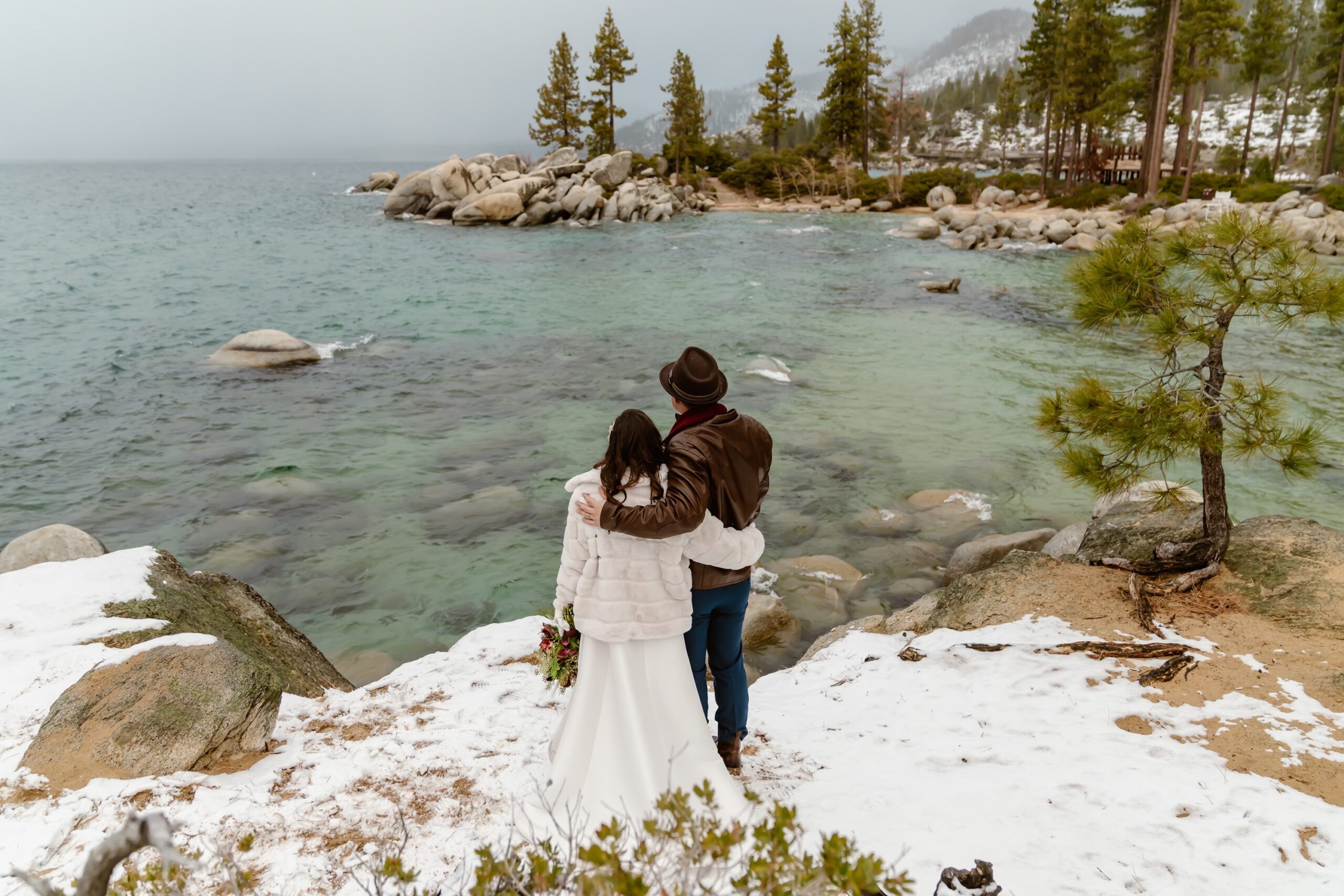 Bride and groom take in views at snowy elopement