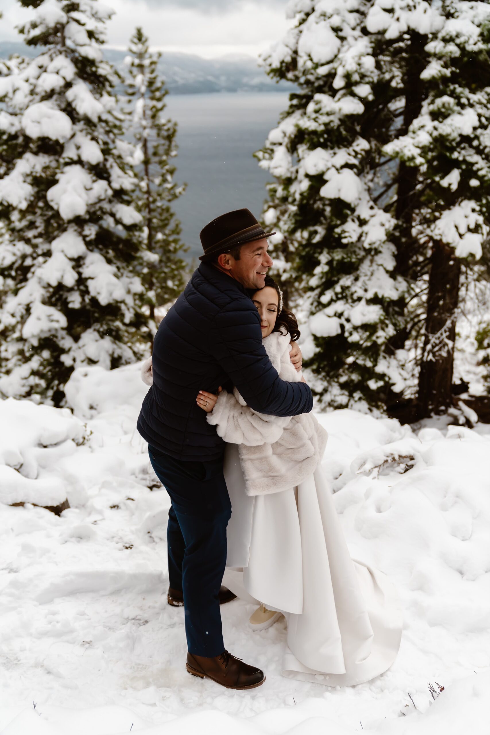 Couple hugs after snowy mountain elopement