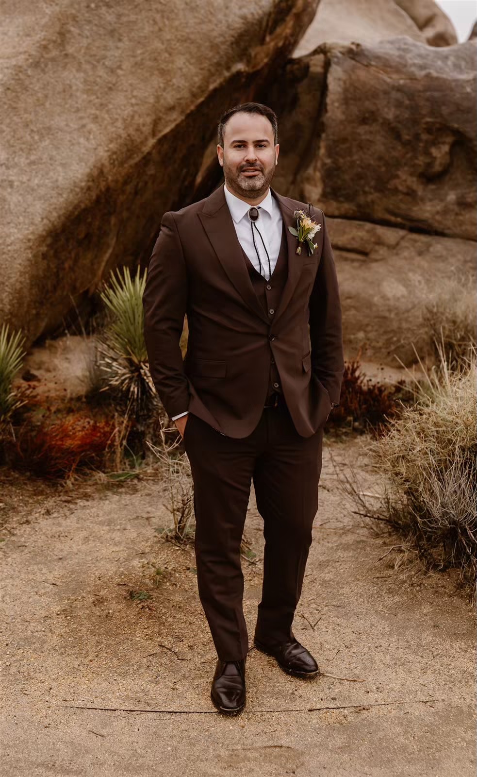 Groom poses for portraits at the Joshua Tree elopement