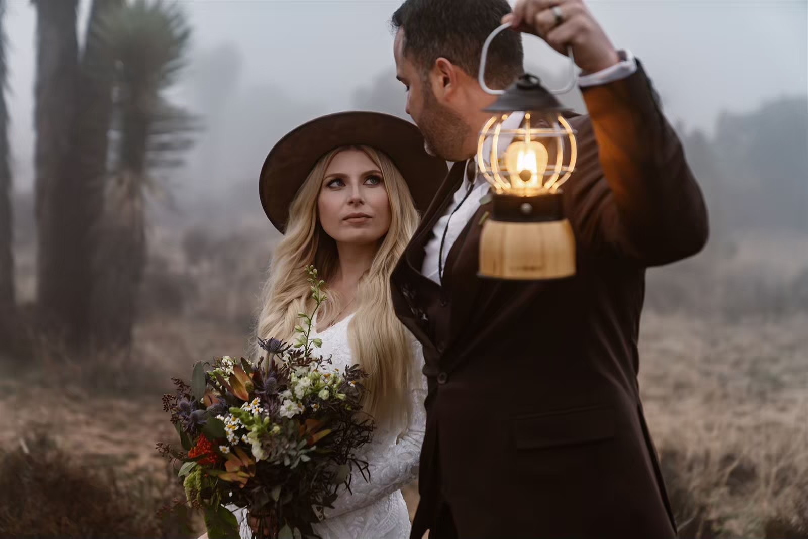 Bride and groom explore Joshua Tree with lanterns