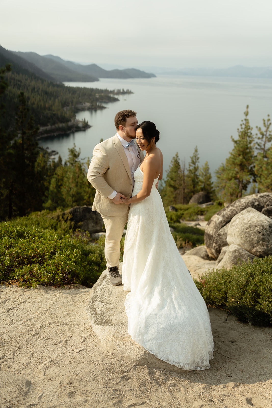 Man kisses woman's cheek at their Monkey Rock elopement