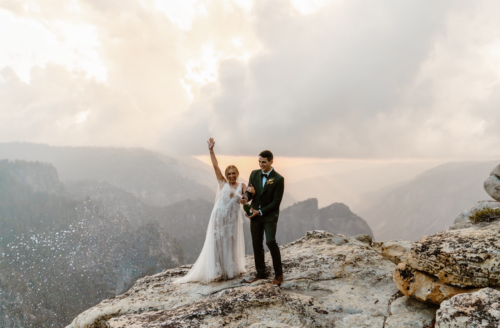 Bride and groom pop champagne at Taft Point