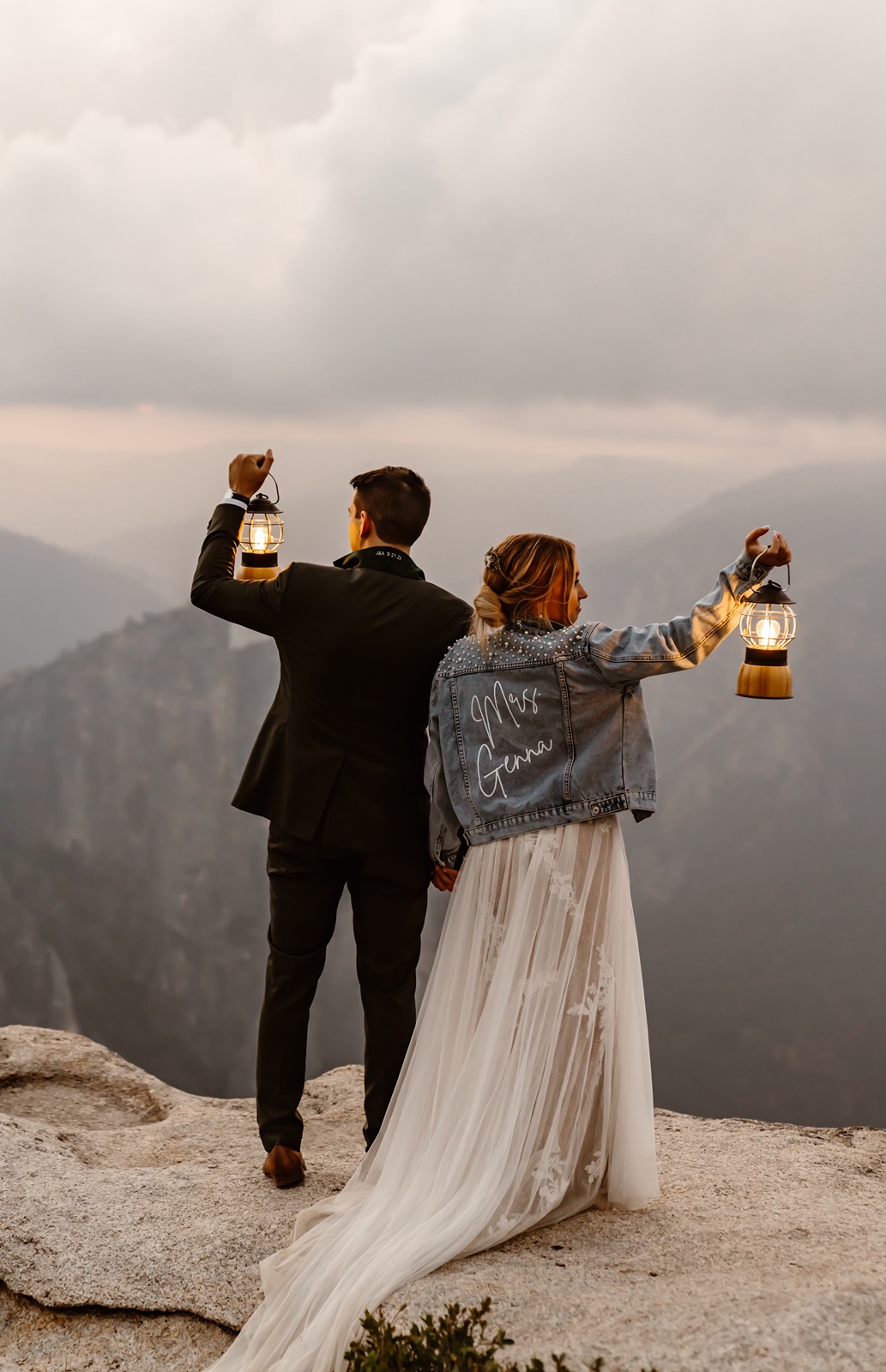 Bride and groom hold lanterns during Taft Point elopement photos