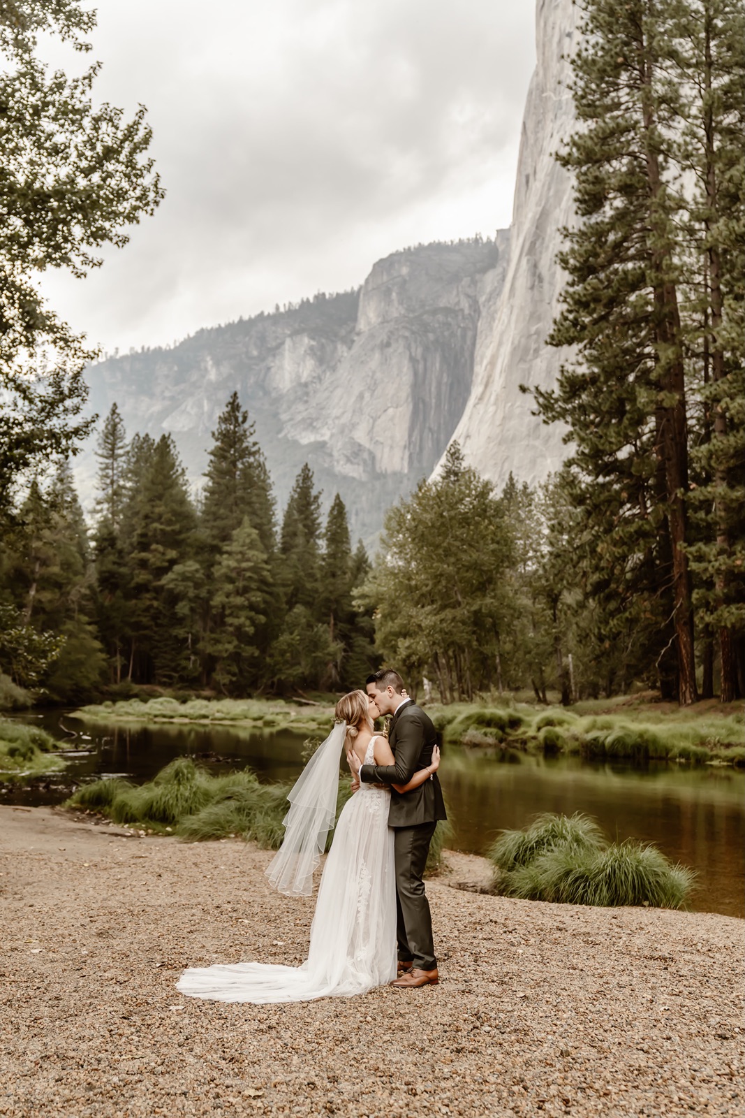 Bride and groom kiss during Cathedral Beach Yosemite wedding ceremony