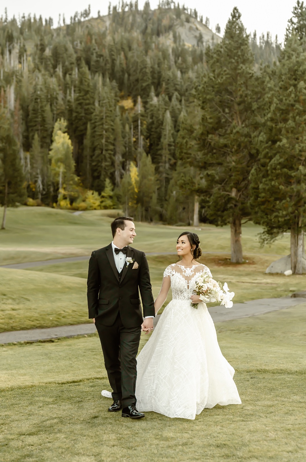 Bride and groom walk on the Everline Resort and Spa property