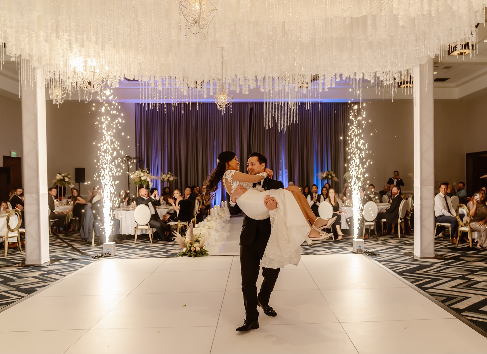 Groom picks up bride during their first dance