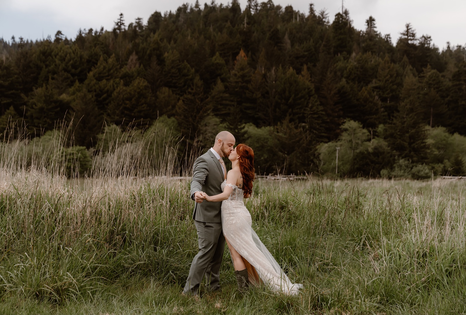 Bride and groom kiss in a pasture in Fern Canyon