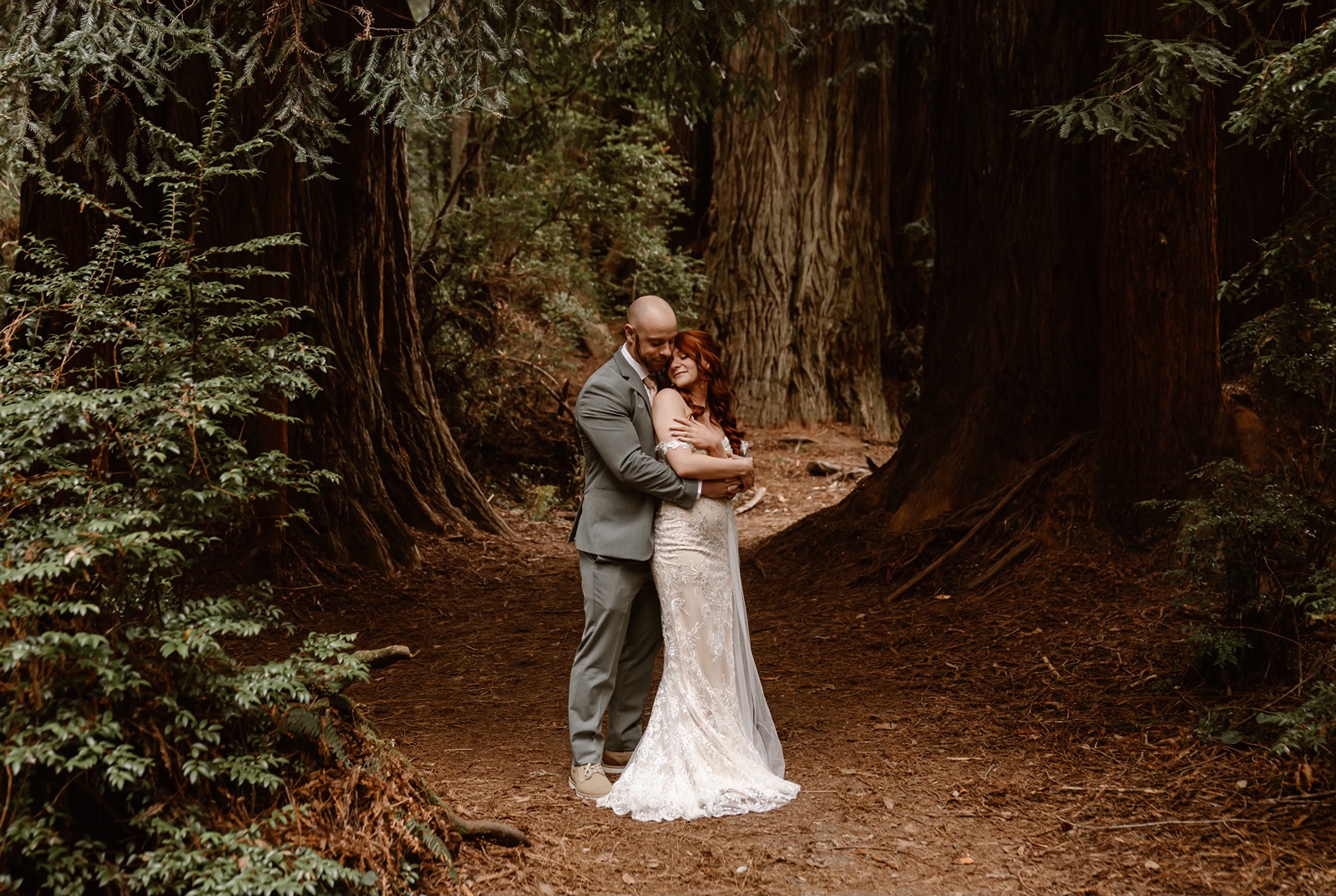 Man wraps arms around woman during elopement in Fern Canyon