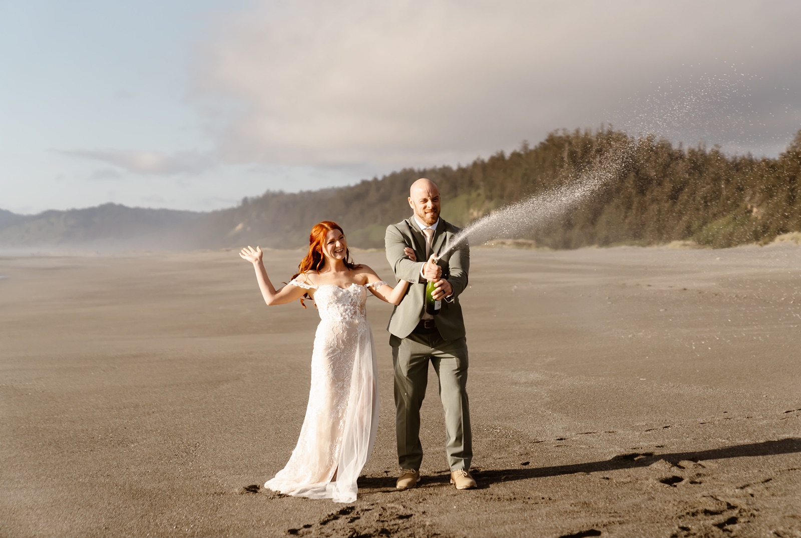 Bride and groom pop champagne during Gold Beach elopement photos