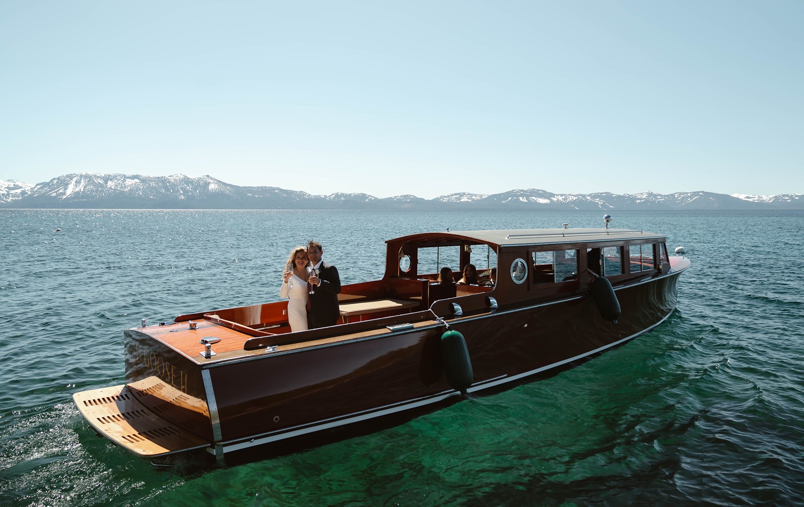 Bride and groom enjoy a boat ride at their Lake Tahoe boat wedding