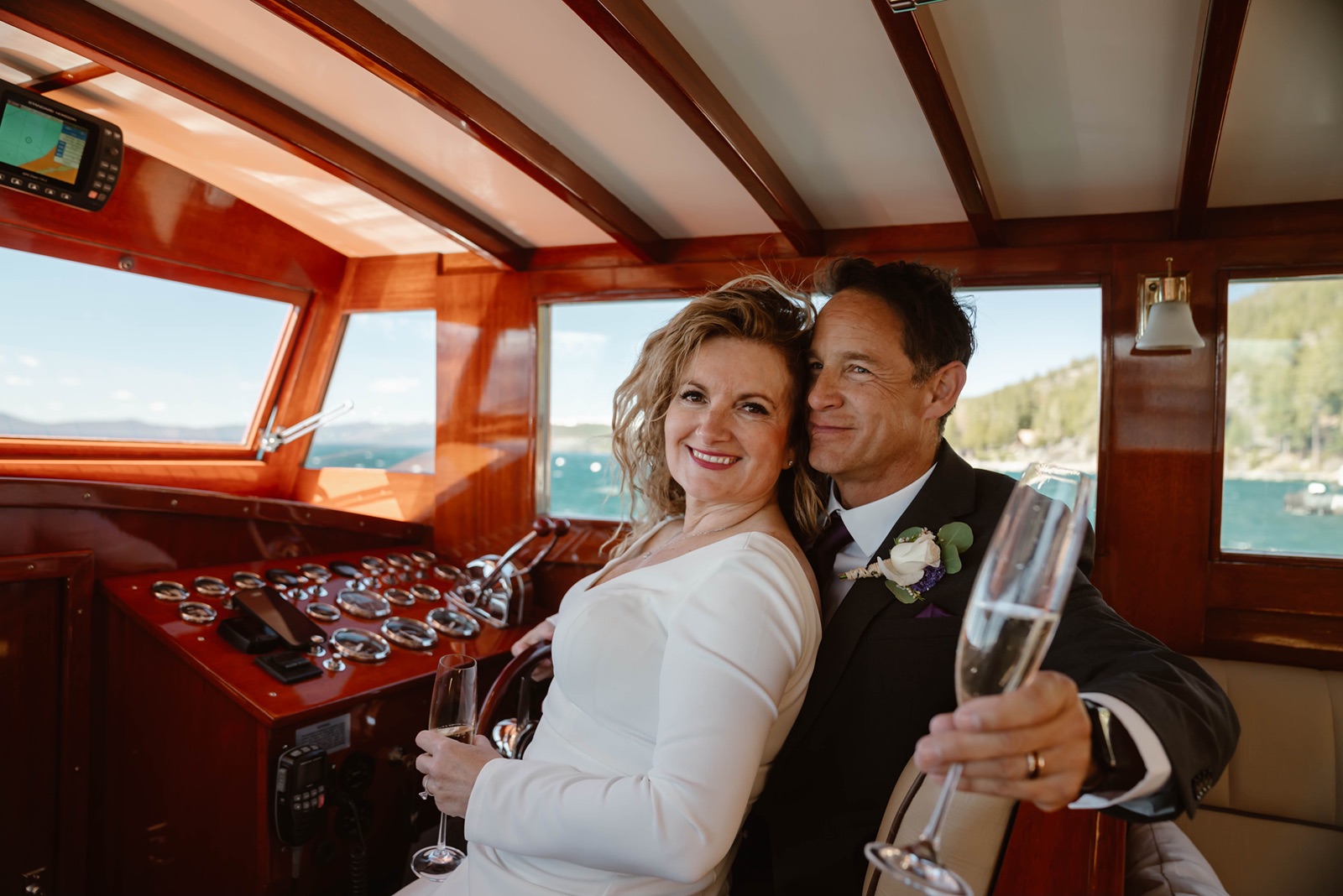 Bride and groom smile together at their Lake Tahoe boat wedding