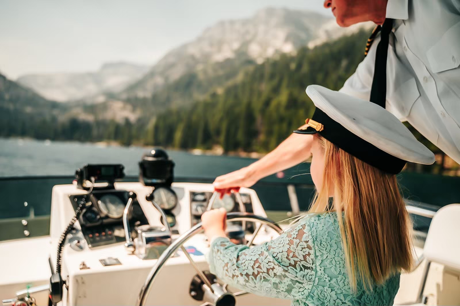 Little girl steers the boat at the Lake Tahoe boat wedding